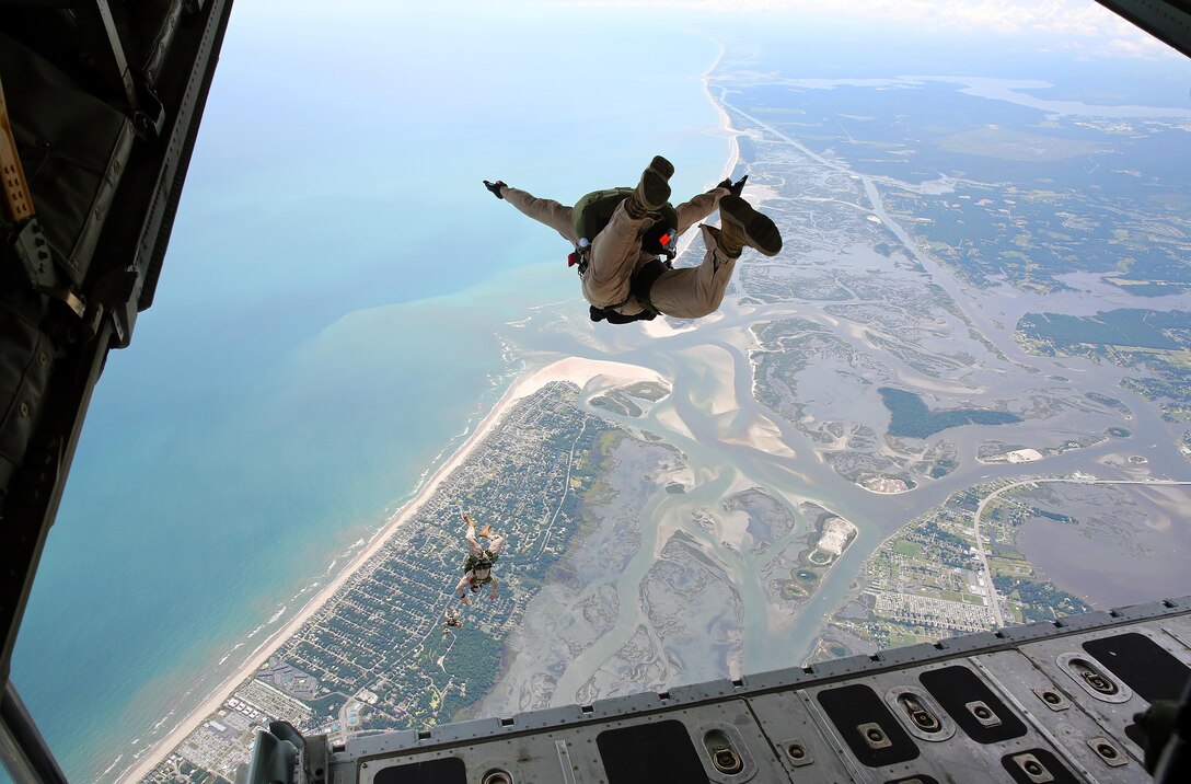 Marines with U.S. Marine Corps Forces, Special Operations Command exit the ramp of a C-130 during a High Altitude Low Opening (HALO) training exercise at an airfield in North Carolina, July 8, 2013.   Marines aboard the aircraft executed freefall and static-line jumps at 10,000 feet. (U.S. Marine Corps photo by Lance Cpl. Steven Fox/Released)