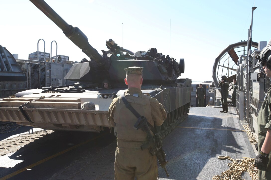 Sgt. Justin L. Waitman, a tank commander with Delta Company, 2nd Tank Battalion, Regimental Landing Team 2, directs an M1A1 Abrams Tank driven by Lance Cpl. Devon R. Shumaker, a tank crewman, in preparation to load on to a landing craft, air cushion before departing to the landing dock platform USS San Antonio during Exercise Bold Alligator 2012 on Feb. 1. This exercise, the largest naval amphibious exercise in the past 10 years, represents the Navy and Marine Corps’ revitalization of the full range of amphibious operations. Bold Alligator is scheduled to run through Feb. 12 afloat and ashore in and around Virginia and North Carolina.