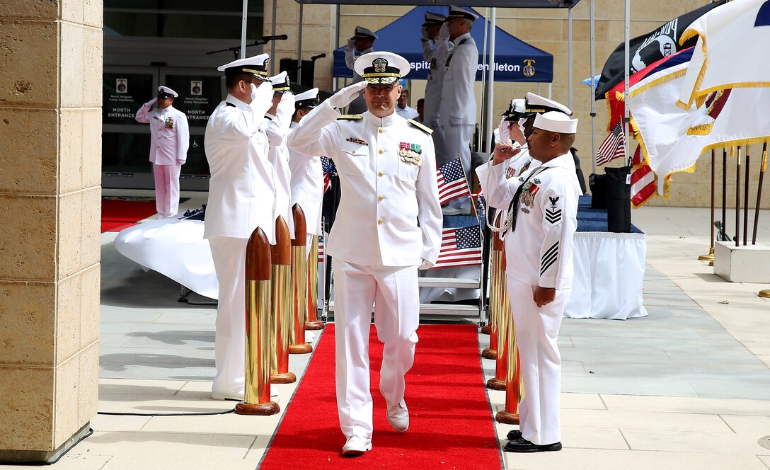 Rear Adm. C. Forrest Faison III Salutes the Sideboys while leaving the reviewing stand at the Naval Hospital Camp Pendleton change of command ceremony here July 26. Faison is the commander of Navy Medicine West and Naval Medical Center San Diego and was the officiating officer and guest speaker for the ceremony. 