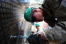 Lance Cpl. Bennett Russ (right) and Lance Cpl. Taylor Tingey add "all-threads" to foundation wall forms while building a handicap-accessible ramp at Erdmiin Oyun School, July 27. U.S. Marines with 9th Engineer Support Battalion and U.S. Army soldiers with 96th Troop Command are working alongside soldiers with the Mongolian Armed Forces in Nalaikh district, Ulaanbaatar, Mongolia during Exercise Khaan Quest 2013. Khaan Quest is a regularly scheduled, multinational exercise co-sponsored this year by U.S. Marine Corps Forces Pacific, and hosted annually by the MAF. The intent of the ongoing engineering civic action program (ENCAP) project in Nalaikh is to provide valuable training for Mongolian and U.S. armed forces by boosting their interoperability, as well as demonstrate a mutual commitment to local community. R