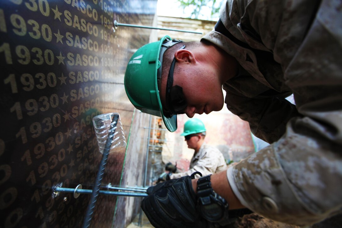 Lance Cpl. Bennett Russ (right) and Lance Cpl. Taylor Tingey add "all-threads" to foundation wall forms while building a handicap-accessible ramp at Erdmiin Oyun School, July 27. U.S. Marines with 9th Engineer Support Battalion and U.S. Army soldiers with 96th Troop Command are working alongside soldiers with the Mongolian Armed Forces in Nalaikh district, Ulaanbaatar, Mongolia during Exercise Khaan Quest 2013. Khaan Quest is a regularly scheduled, multinational exercise co-sponsored this year by U.S. Marine Corps Forces Pacific, and hosted annually by the MAF. The intent of the ongoing engineering civic action program (ENCAP) project in Nalaikh is to provide valuable training for Mongolian and U.S. armed forces by boosting their interoperability, as well as demonstrate a mutual commitment to local community. 