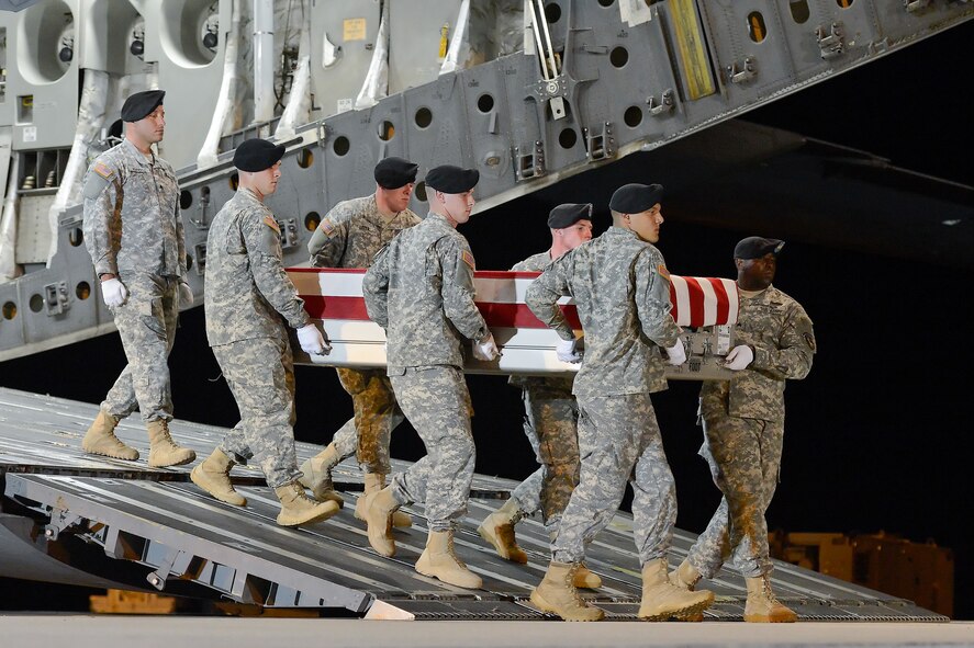 A U.S. Army carry team transfers the remains of Sgt. Caryn E. Nouv, of Newport News, Va., during a dignified transfer July 29, 2013 at Dover Air Force Base, Del. Nouv was assigned to the 10th Transportation Battalion, 7th Sustainment Brigade, Joint Base Langley-Eustis, Va. (U.S. Air Force photo/Greg L. Davis)