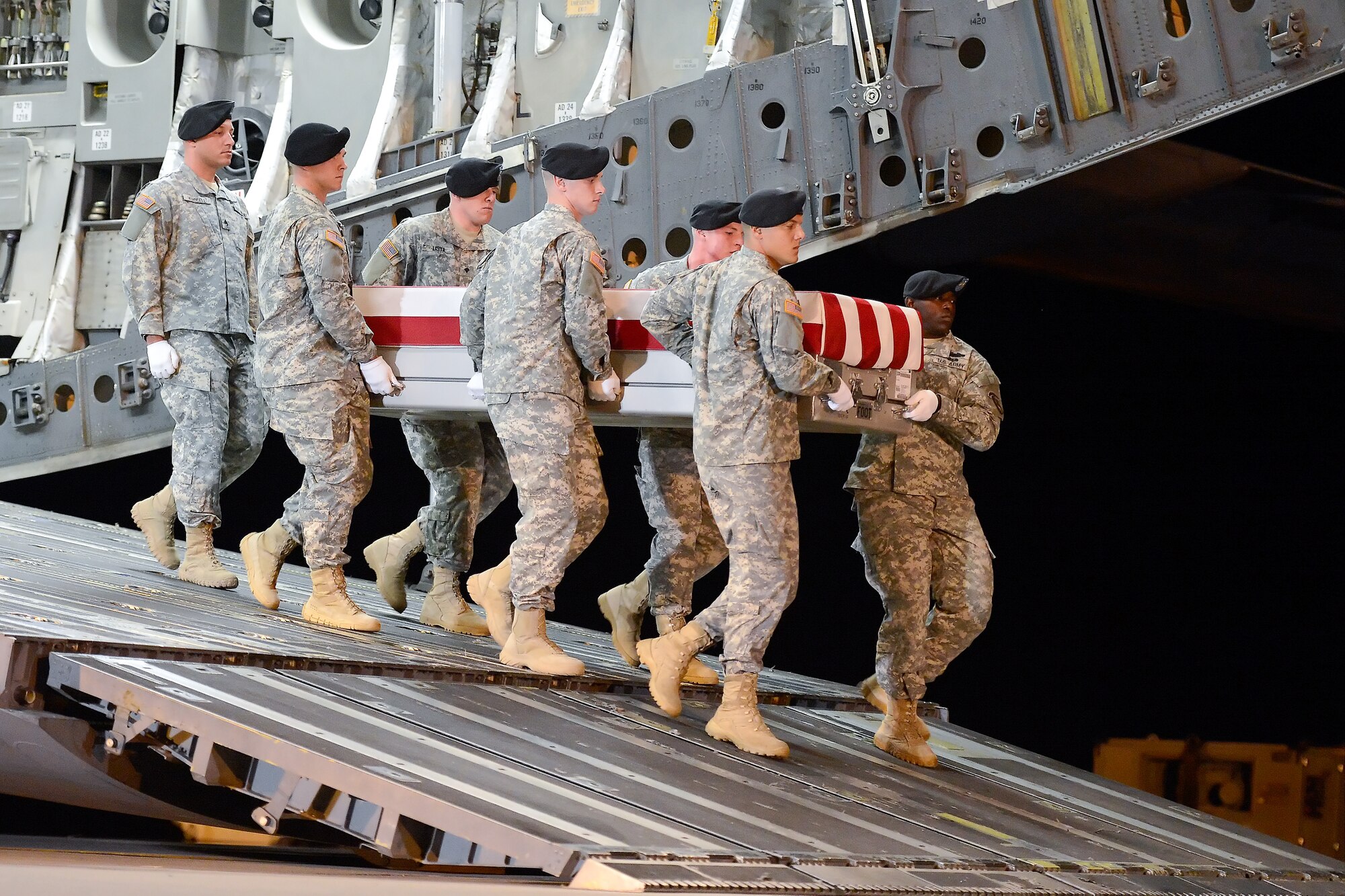 A U.S. Army carry team transfers the remains of Sgt. Eric T. Lawson, of Stockbridge, Ga., during a dignified transfer July 29, 2013 at Dover Air Force Base, Del. Lawson was assigned to the 10th Transportation Battalion, 7th Sustainment Brigade, Joint Base Langley-Eustis, Va. (U.S. Air Force photo/Greg L. Davis)
