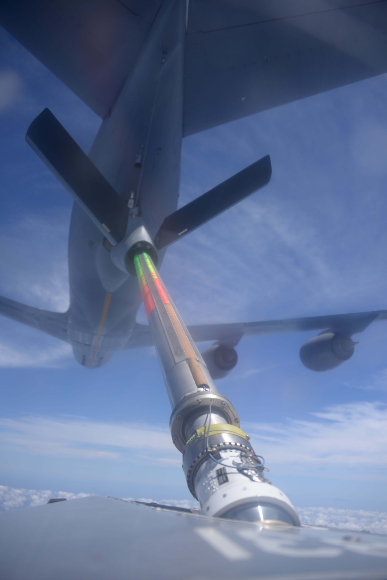 A KC-135 Stratotanker from the 909th Air Refueling Squadron connects to an MC-130P Combat Shadow from the 17th Special Operations Squadron during an air-to-air refueling mission over the East China Sea July 19, 2013.  The squadrons regularly conduct air-to-air refueling missions in order to ensure training proficiency for aircrews in both units.. (U.S. Air Force photo  by Tech. Sgt. Kristine Dreyer)