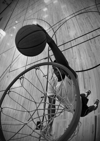 Airman 1st Class Cedric King II, 92nd Force Support Squadron career development apprentice, dunks a basketball during a practice session at the fitness center at Fairchild Air Force Base, Wash., July 25, 2013. King will be attending the training camp for the Air Force basketball team in October. (U.S. Air Force photo by Senior Airman Taylor Curry/Released) 