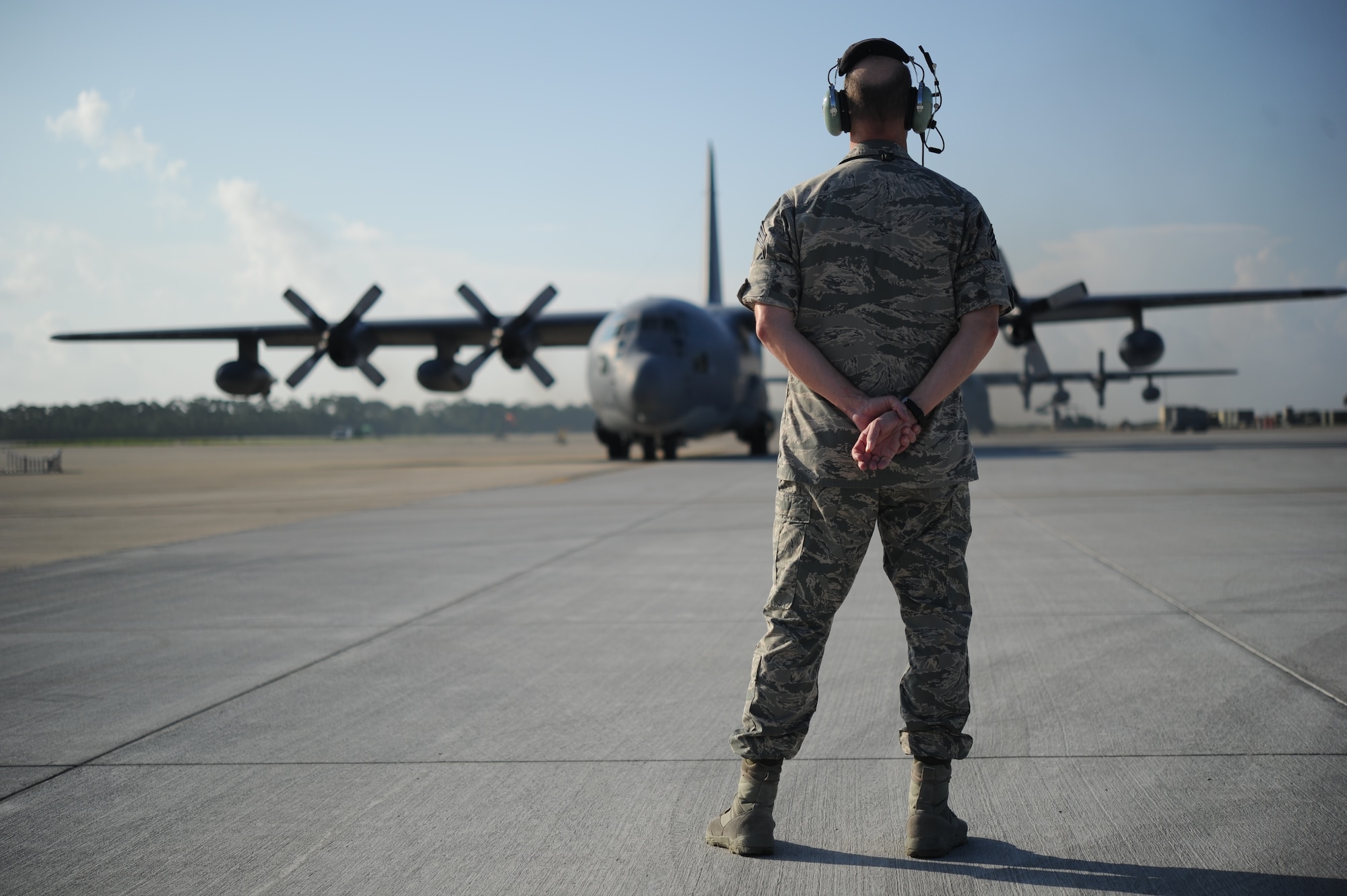 Chief Master Sgt.Scott Doremus, maintenance superintendent of the 1st Special Operations Aircraft Maintenance Squadron, prepares to marshal out a MC-130P Combat Shadow for the last time at Hurlburt Field, Fla., July 29, 2013. Doremus wrked on this aircraft throughtout his Air Force career for the past 28 years. (U.S. Air force photo/Staff Sgt. Eboni Reams)