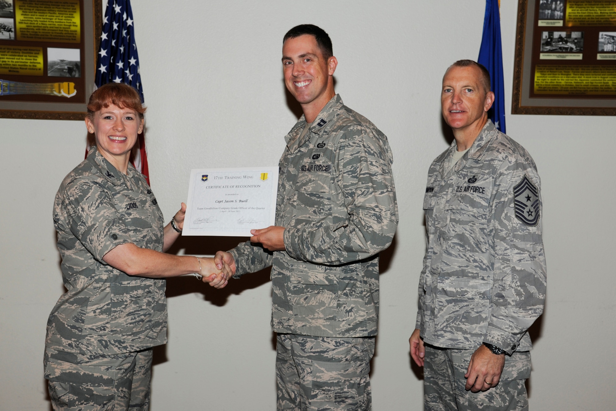 GOODFELLOW AIR FORCE BASE, Texas -- Col. Kimberlee Joos, 17th Training Wing Commander, and Chief Master Sgt. Scott Lumpkin, 17th TRW Command Chief, present the 17th Training Wing Team GAFB CGO Service Member of the Quarter to Capt Jason Buell, 17th Mission Support Group, during the wing quarterly awards ceremony, July 25. (U.S. Air Force photo by Staff Sgt. Austin Knox)