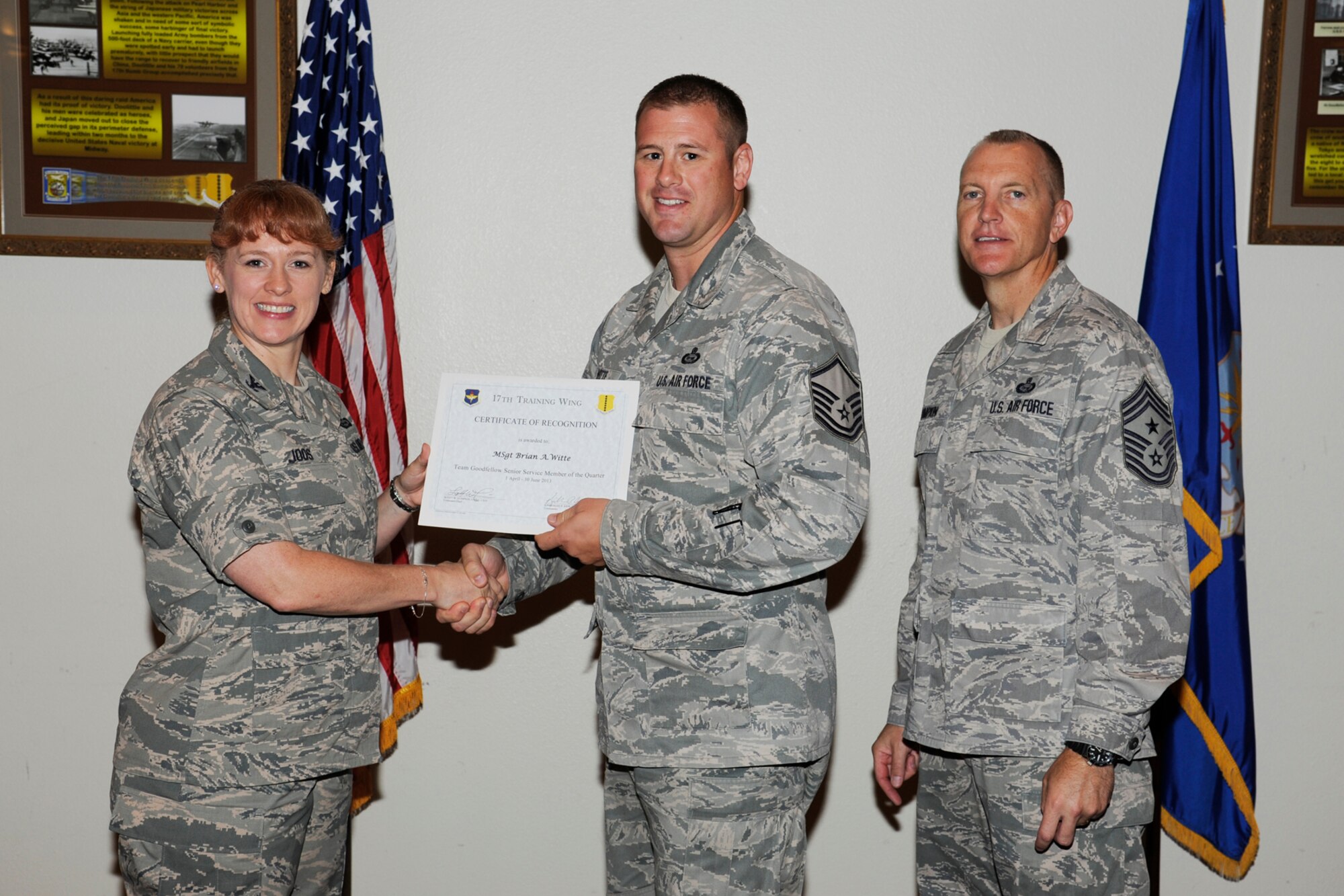 GOODFELLOW AIR FORCE BASE, Texas -- Col. Kimberlee Joos, 17th Training Wing Commander, and Chief Master Sgt. Scott Lumpkin, 17th TRW Command Chief, present the 17th Training Wing Team GAFB Senior Service Member of the Quarter to Master Sgt. Brian Witte, 17th Training Group, during the wing quarterly awards ceremony, July 25. (U.S. Air Force photo by Staff Sgt. Austin Knox)