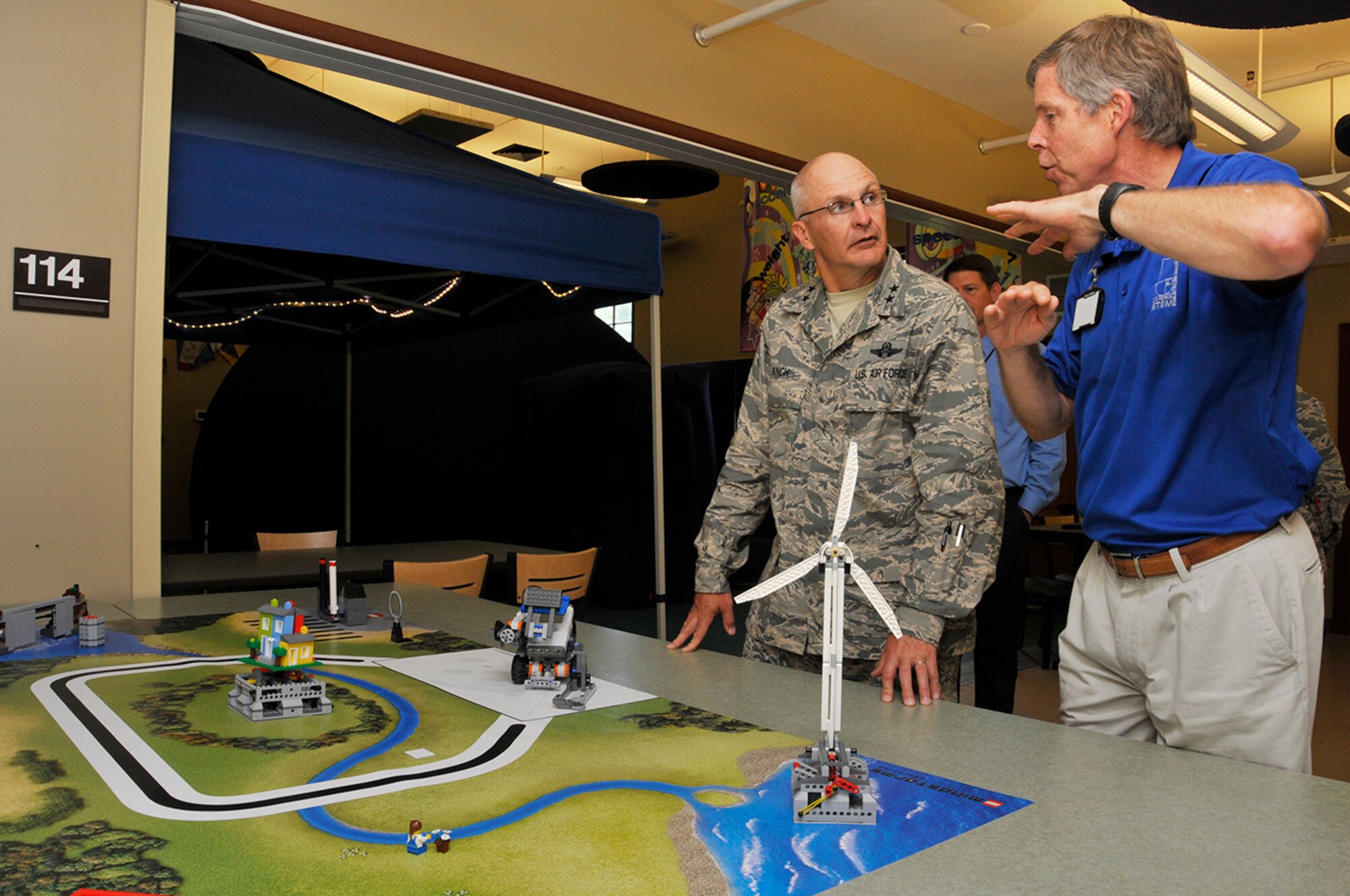 Maj. Gen. Arnold Bunch (left) learns about the STEM Center’s LEGO® robotics program from Jere Matty, STEM educational outreach specialist. (Photo by Rick Goodfriend)