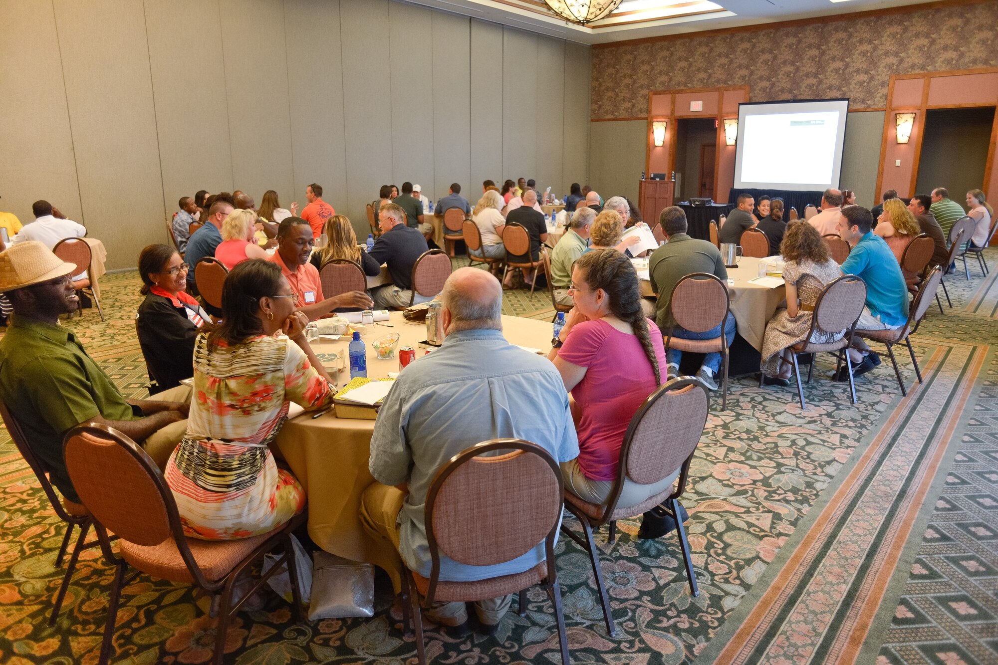 Couples from the 116th Air Control Wing (ACW) and the 202nd Engineering Installation Squadron, Georgia Air National Guard, talk with one another at the start of the Strong Bonds marriage conference at Callaway Gardens, Pine Mountain, Ga., July 26, 2013.  The conference is a chaplain led program, developed by the National Guard Bureau, offering three days of intensive training in a retreat like setting designed to help Guardsmen build and maintain a strong family structure.  Twenty nine couples attended the event hosted by the 116th ACW. (U.S. Air National Guard photo by Master Sgt. Roger Parsons/Released)