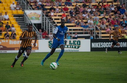 Dane Kelly from the Charleston Battery, moves the ball against a defender  July 27, 2013 during Military Appreciation Night at Blackbaud Stadium, Daniel Island, S.C. The Charleston Battery hosted Military Appreciation Night to show their support for the local military community. (U.S. Air Force photo/Senior Airman Ashlee Galloway)
