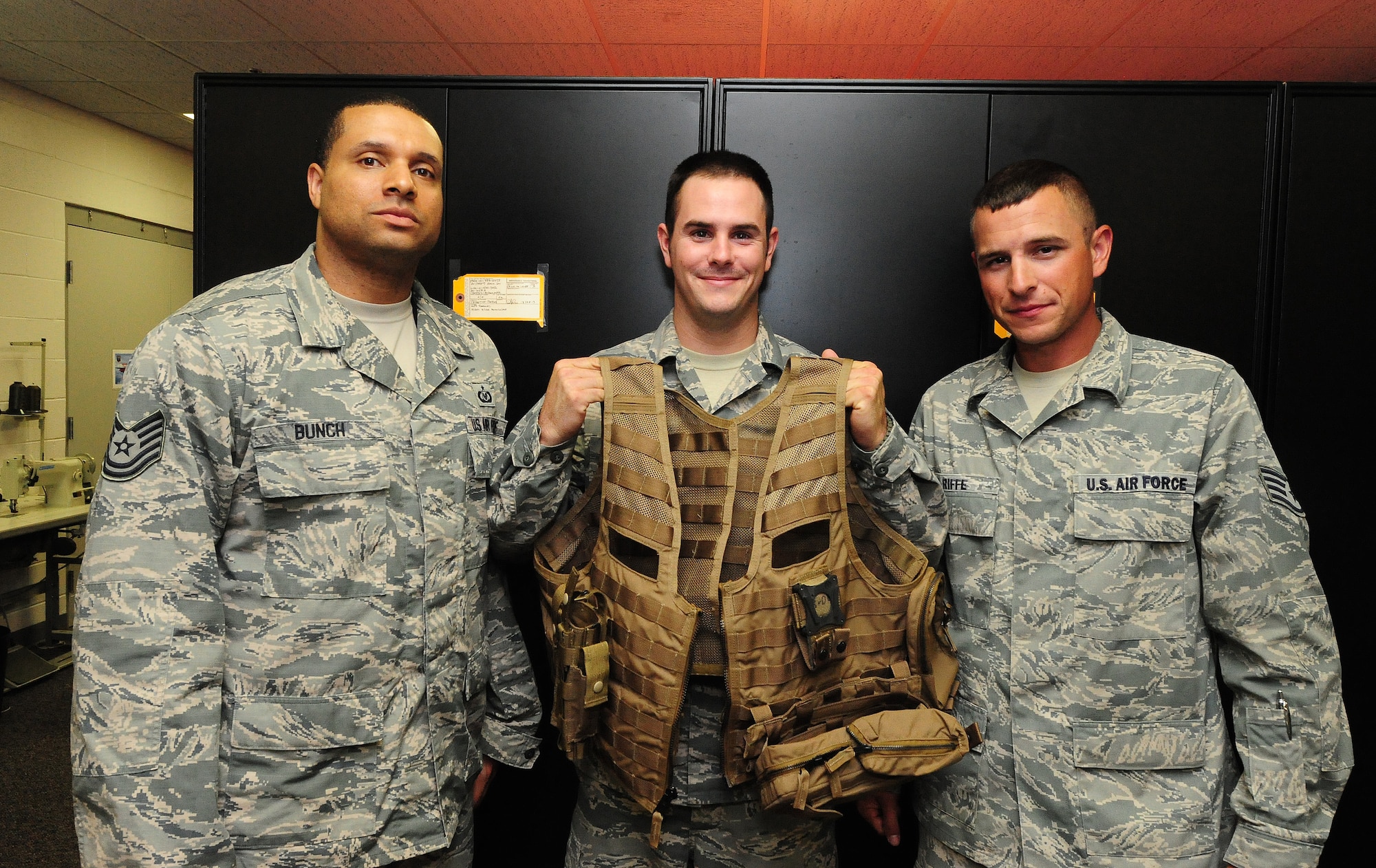 Technical Sgt. Damian Bunch, Senior Airman Ethan Mason, and Staff Sgt. Josh Riffe, aircrew flight equipment members from the 509th Operations Support Squadron pose with a fully constructed Airsave vest at Whiteman Air Force Base, Mo., July 12, 2013. Along with Airman 1st Class Matthew Ford, 509th OSS aircrew flight equipment journeyman, these Airmen were the first individuals on base to be trained on the Air Force’s new Airsave vest system. (U.S. Air Force photo by Staff Sgt. Nick Wilson/Released)