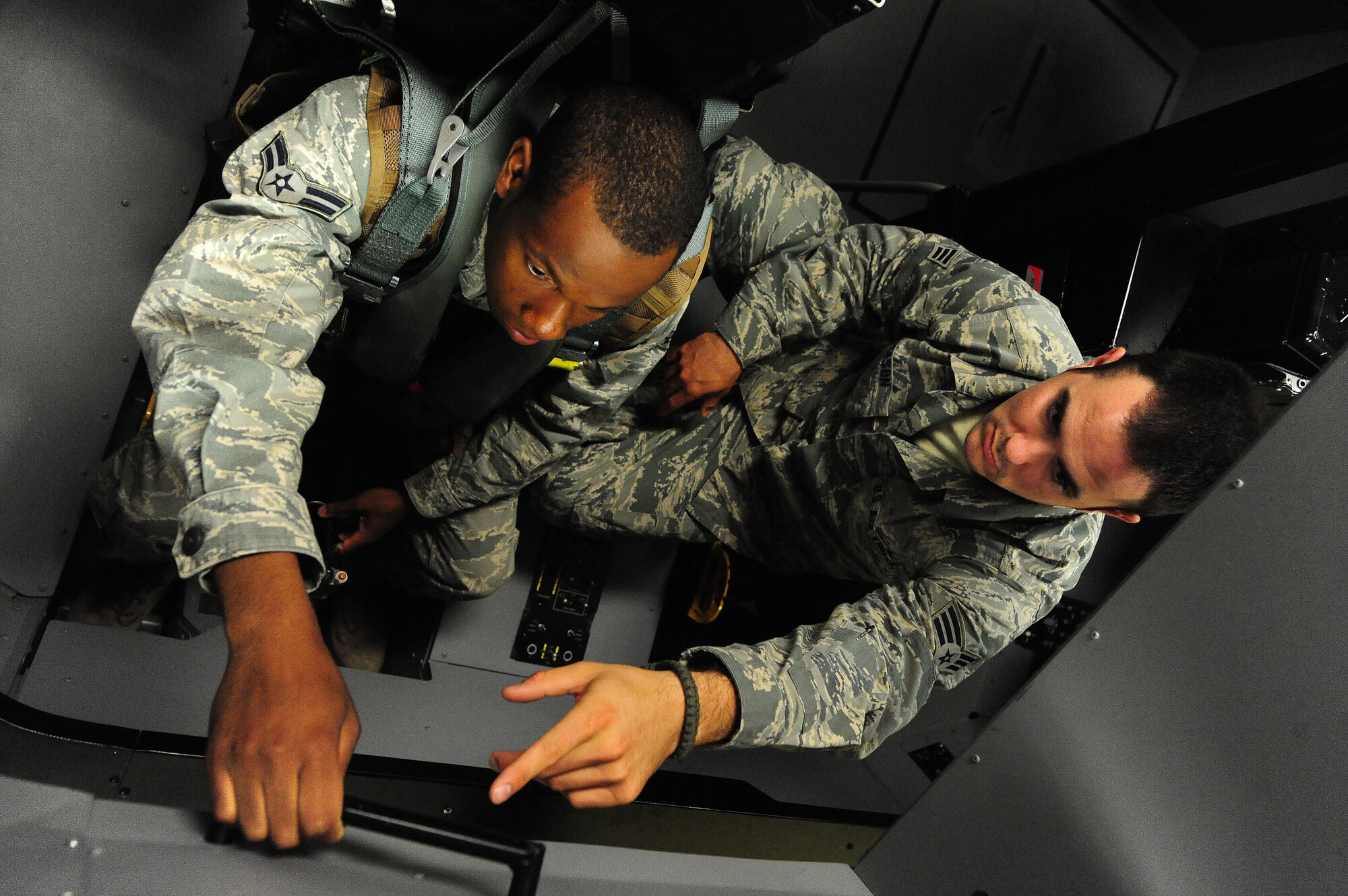 Airman 1st Class Dalvin Washington receives training from fellow 509th Operations Support Squadron aircrew flight equipment member Senior Airman Ethan Mason at Whiteman Air Force Base, Mo., July 16, 2013.  This was done as part of a training scenario with the first wave of Airsave technicians, who were equipped to then train other OSS members. (U.S. Air Force photo by Staff Sgt. Nick Wilson/Released)
