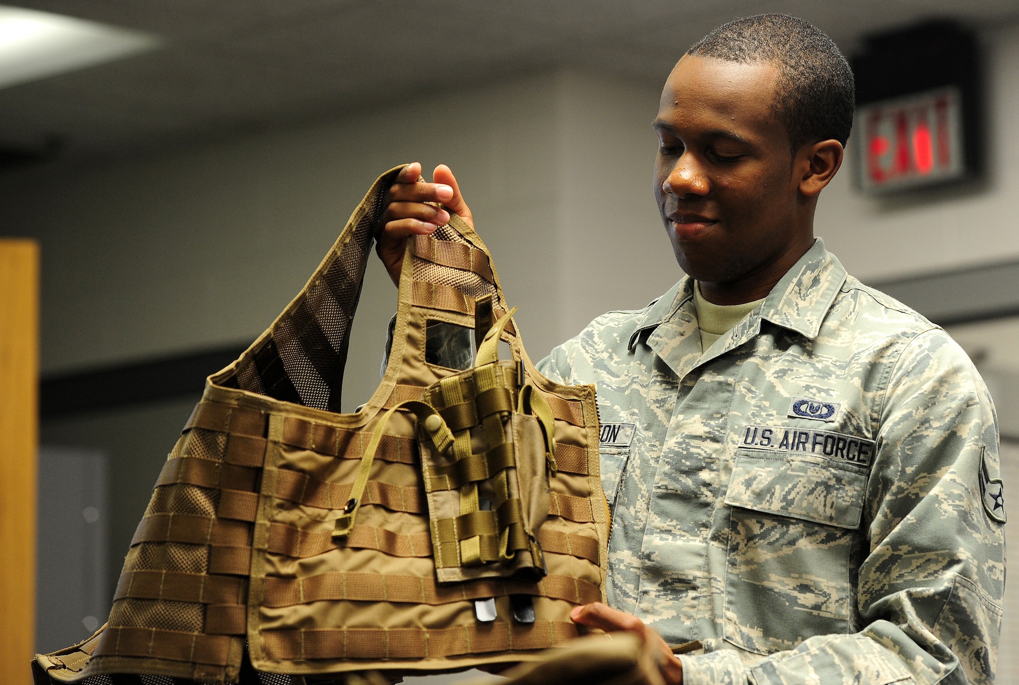 Airman 1st Class Dalvin Washington, 509th Operations Support Squadron aircrew flight equipment apprentice, prepares to don an Airsave vest during a training scenario at Whiteman Air Force Base, Mo., July 16, 2013. The AFE shop recently received two brand-new Airsave vests from Air Combat Command to research their advantages and disadvantages as compared to older vest styles. (U.S. Air Force photo by Staff Sgt. Nick Wilson/Released)