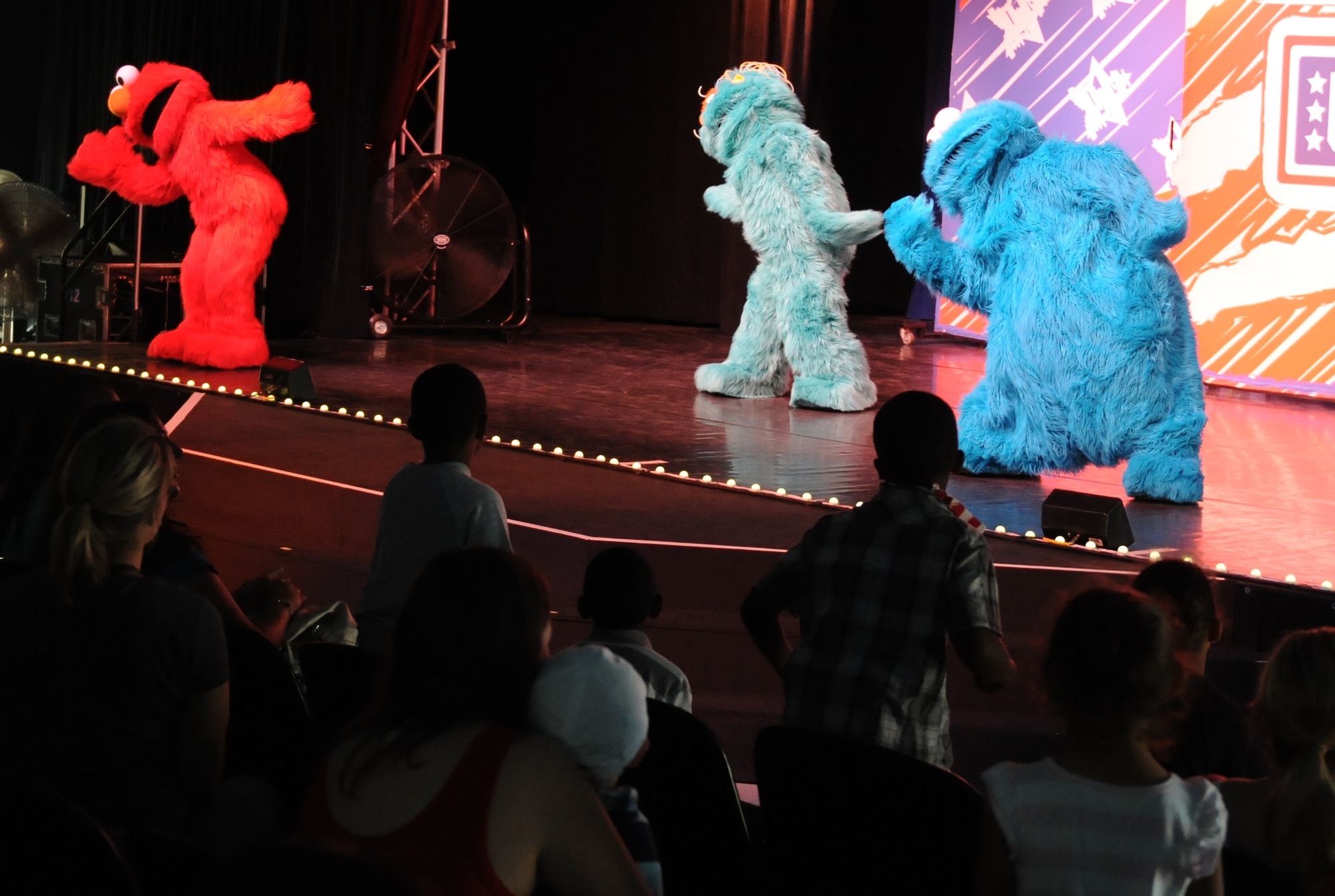 Sesame Street characters perform for members of the KMC during the “Sesame Street USO Experience for Military Families” show, July 24, 2013, Kleber Kaserne, Germany. Members of the show are traveling to U.S. military bases around the world in support of military members and their families. (U.S. Air Force photo/Airman 1st Class Holly Mansfield)