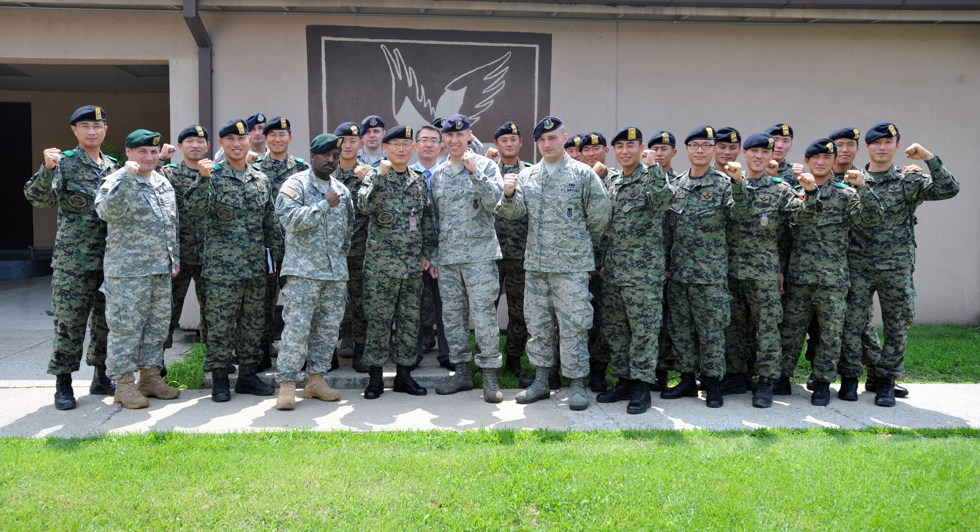 Members of the 51st Security Forces Squadron pose for a photo with members of the 9th Battalion, 51st Infantry Division, Republic of Korea army, and two members of the U.S. Army at Osan Air Base, ROK, July 25, 2013. The ROKA’s special forces unit was on hand to have their first face-to-face meeting with the 51st Security Forces Squadron air base defense and intelligence section. (U.S. Air Force photo/Senior Airman Siuta B. Ika)