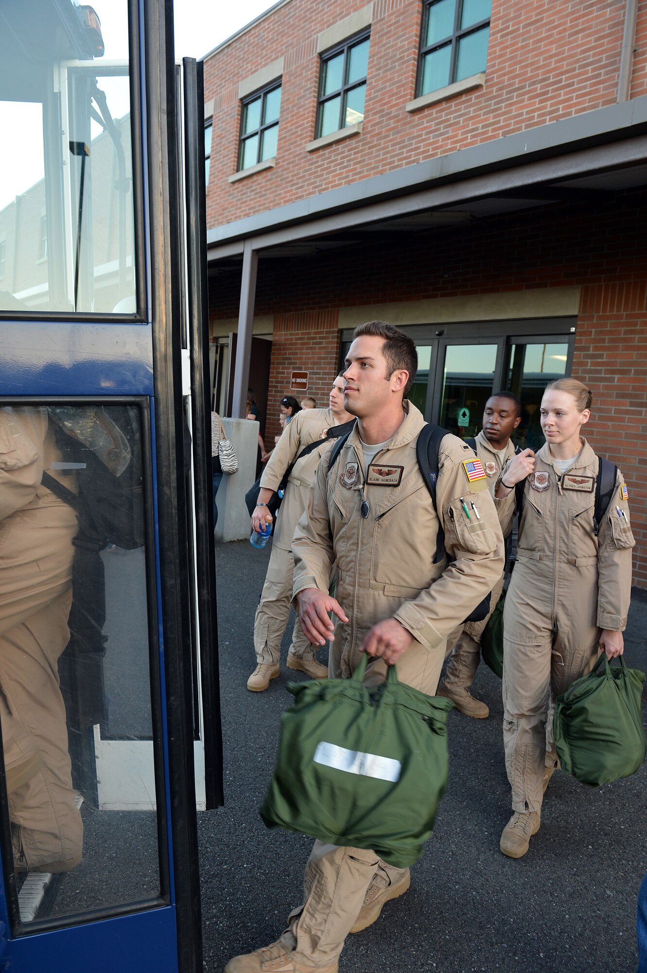 Airmen from the 10th Airlift Squadron board a bus preparing to depart for their deployment, July 28, 2013, at Joint Base Lewis-McChord, Wash. During the scheduled 2-month deployment, the Airmen will operate out of two bases, managing and flying missions in and around Southwest Asia. (U.S. Air Force photo/Airman 1st Class Jacob Jimenez)