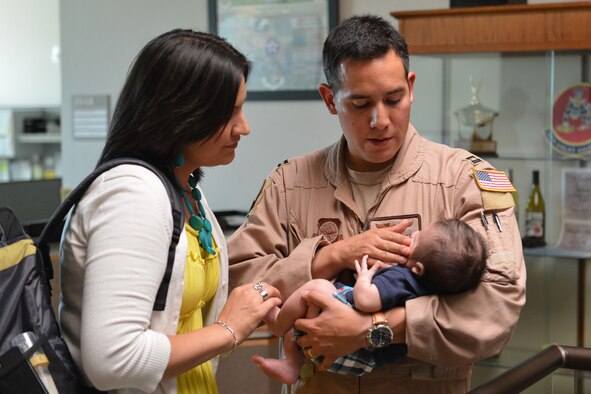 Capt. Geraldo Garza, 10th Airlift Squadron pilot, enjoys a moment with his wife and son as he prepares to depart for a 60-day deployment in support of Operation Enduring Freedom, July 28, 2013, at Joint Base Lewis-McChord, Wash. Garza, along with approximately 70 other Airmen of the 10th AS will take over operations of the 817th Expeditionary Airlift Squadron in Southwest Asia. (U.S. Air Force photo/Airman 1st Class Jacob Jimenez)