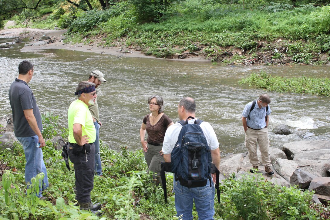 Participants in a stream restoration workshop observe the Tacony Creek on July 23, 2013. The workshop was hosted by the U.S. Army Corps of Engineers, the Environmental Protection Agency and the Philadelphia Water Department and included participants from federal, state and local agencies.