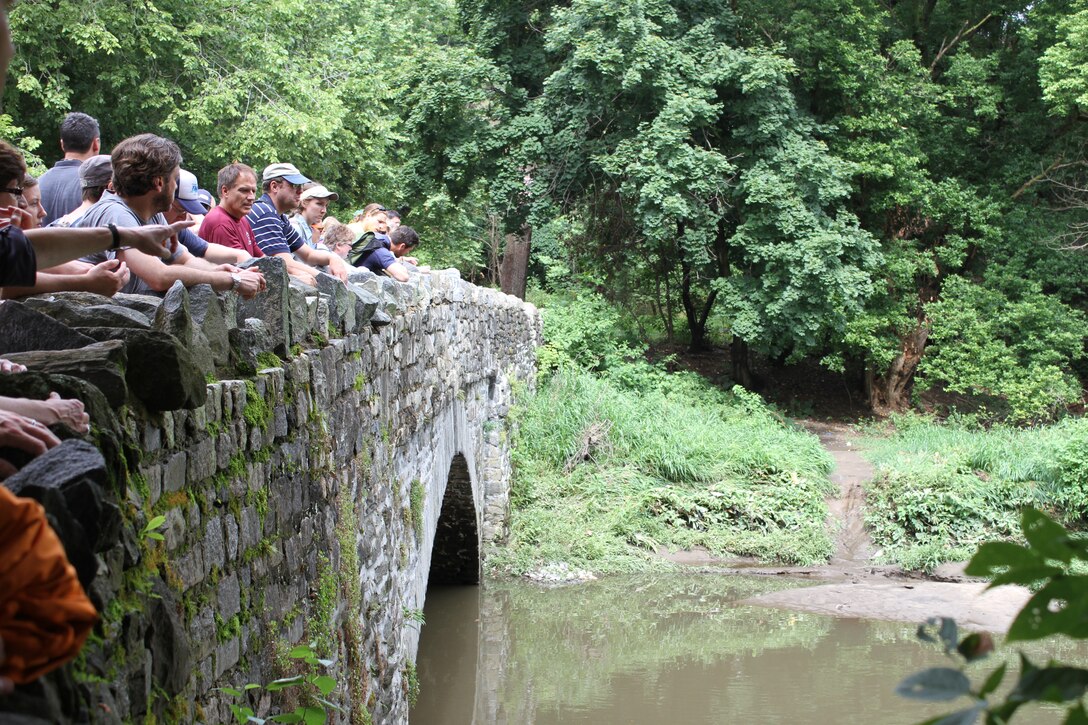 Participants in a stream restoration workshop observe the Tacony Creek from the Fisher's Avenue Bridge on July 23.  The workshop was hosted by the U.S. Army Corps of Engineers, the Environmental Protection Agency and the Philadelphia Water Department and included participants from federal, state and local agencies. 