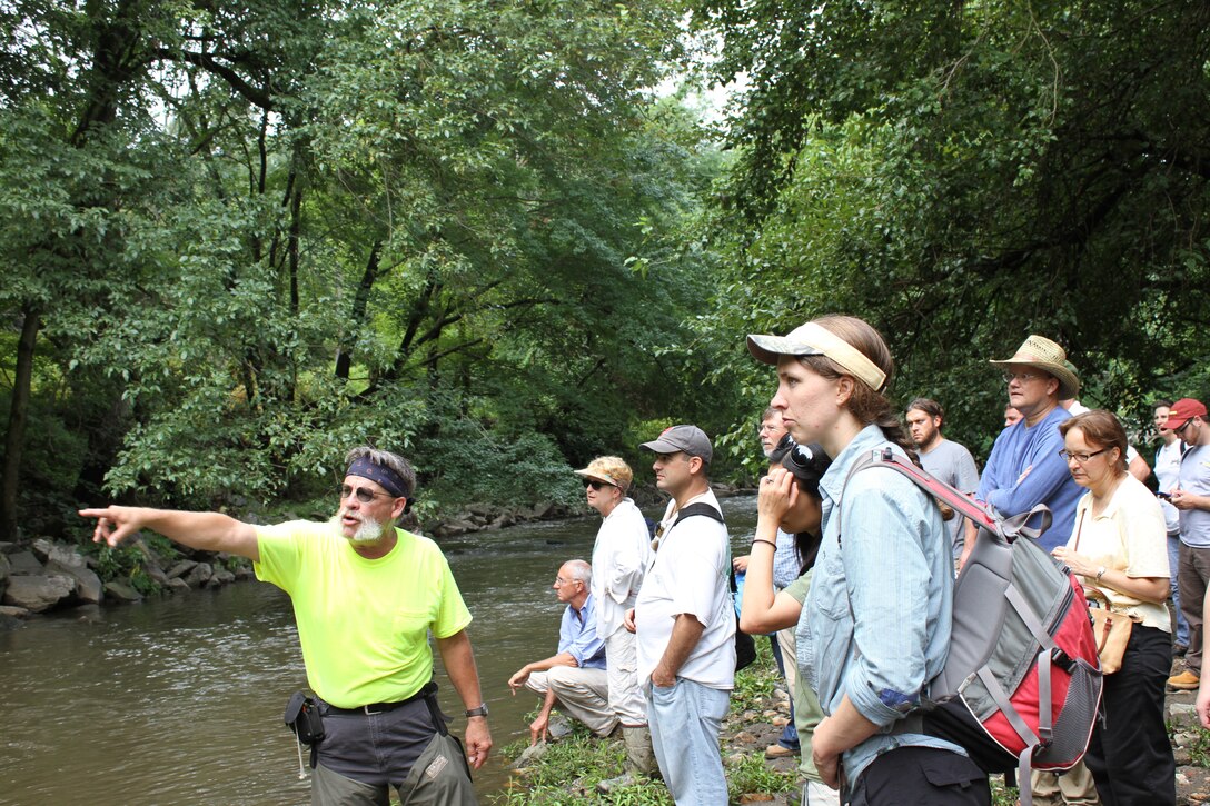 Dave Derrick, Research Hydraulic Engineer (left) explains how the Army Corps of Engineers restored the functionality of a section of the Tacony Creek in Philadelphia during a workshop July 23. The workshop was hosted by the U.S. Army Corps of Engineers, the Environmental Protection Agency and the Philadelphia Water Department and included participants from federal, state and local agencies.