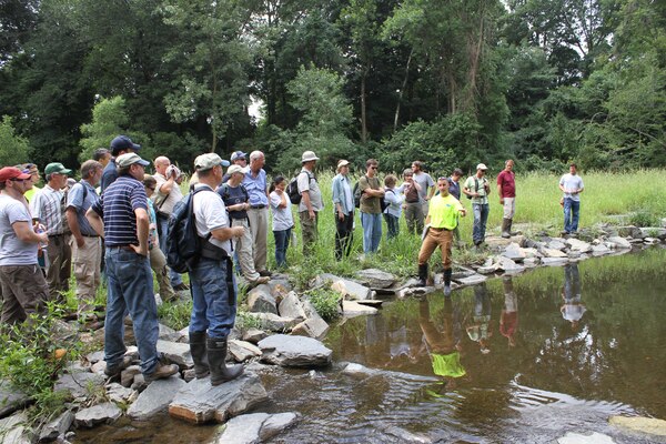 Erik Haniman (middle), manager of the Ecological Restoration Group for the Philadelphia Water Department, discusses the design of the Cobbs Creek (Indian Creek) Habitat Restoration during a stream restoration workshop in Philadelphia July 23. The workshop was hosted by the U.S. Army Corps of Engineers, the Environmental Protection Agency and the Philadelphia Water Department and included participants from federal, state and local agencies.