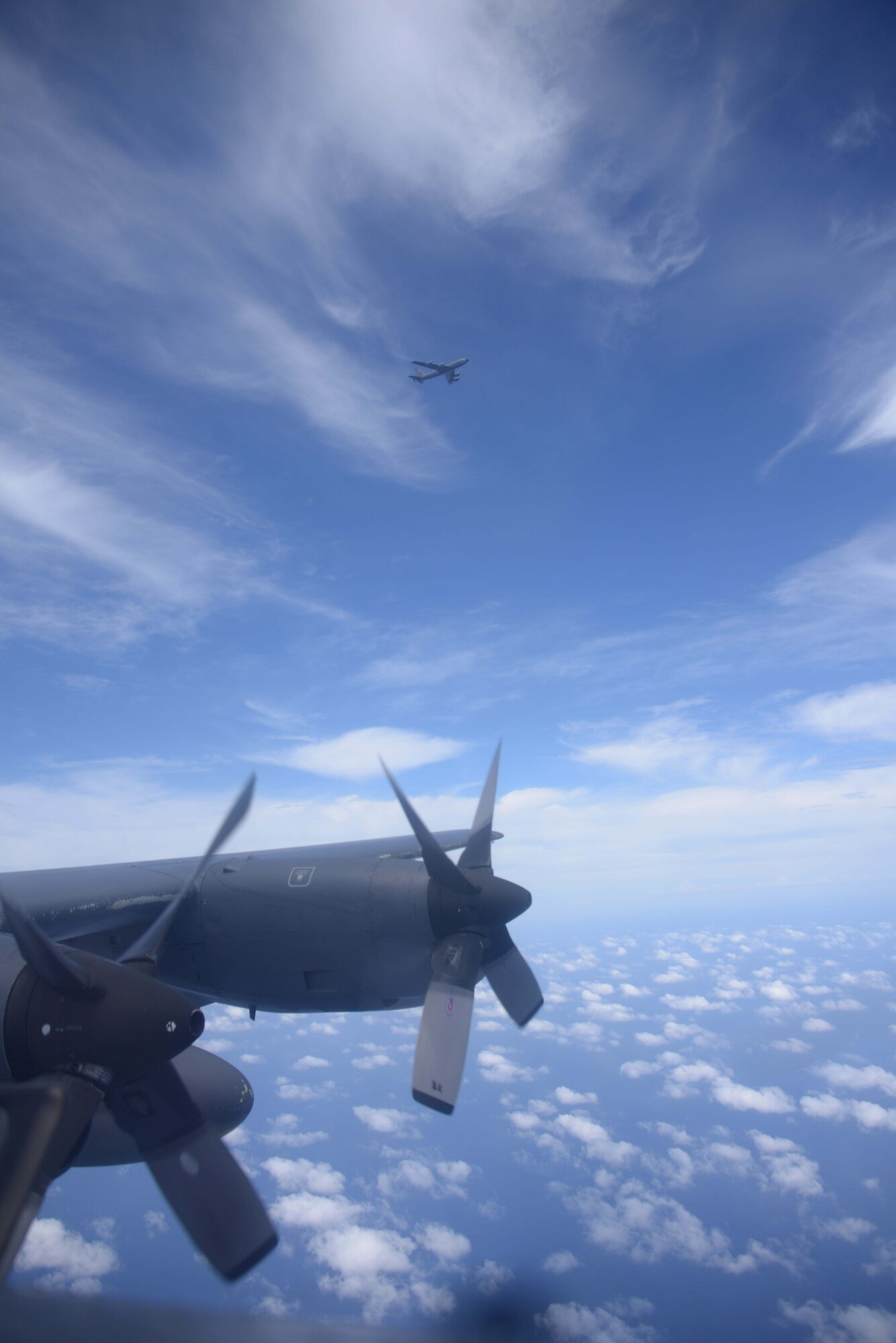 A KC-135 Stratotanker from the 909th Air Refueling Squadron approaches an MC-130P Combat Shadow from the 17th Special Operations Squadron during an air-to-air refueling mission over the East China Sea July 19, 2013.  The squadrons regularly conduct air-to-air refueling missions in order to ensure training proficiency for aircrews in both units. (U.S. Photo by Tech. Sgt. Kristine Dreyer)