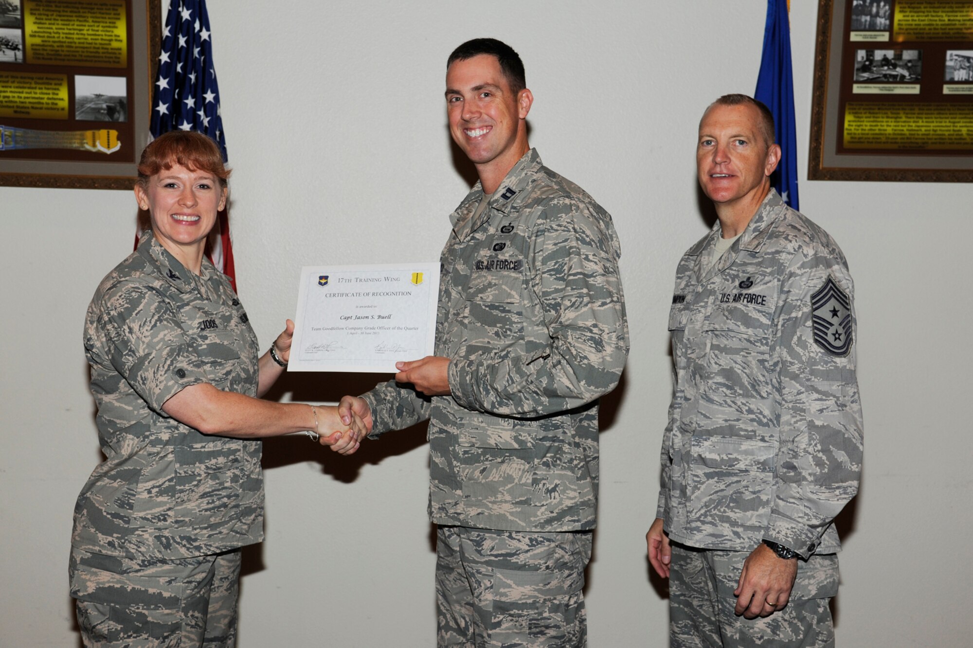 GOODFELLOW AIR FORCE BASE, Texas -- Col. Kimberlee Joos, 17th Training Wing Commander, and Chief Master Sgt. Scott Lumpkin, 17th TRW Command Chief, present the 17th Training Wing Team GAFB CGO Service Member of the Quarter to Capt Jason Buell, 17th Mission Support Group, during the wing quarterly awards ceremony, July 25. (U.S. Air Force photo by Staff Sgt. Austin Knox)