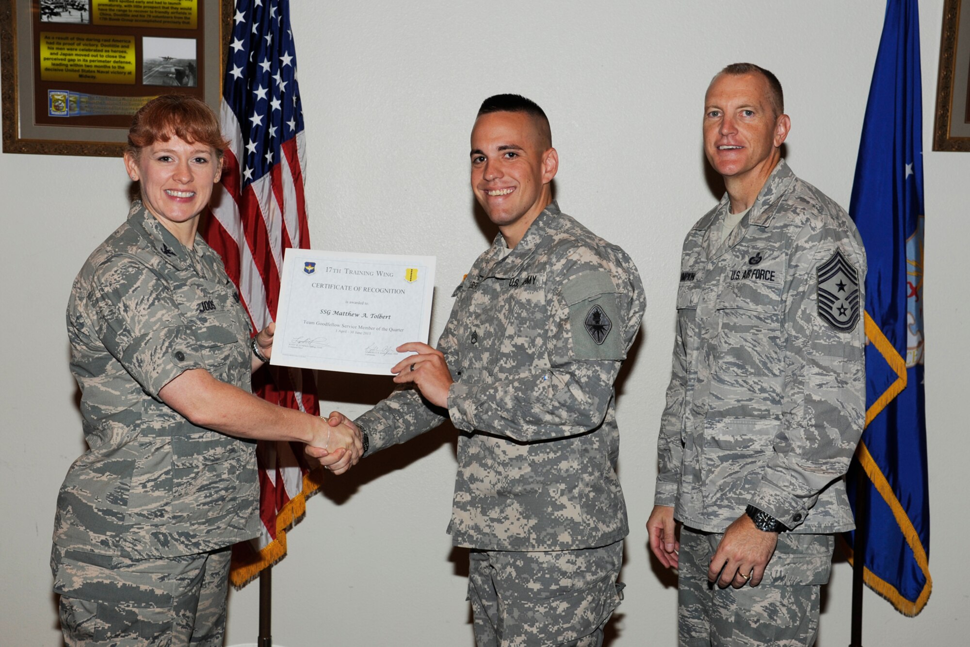 GOODFELLOW AIR FORCE BASE, Texas -- Col. Kimberlee Joos, 17th Training Wing Commander, and Chief Master Sgt. Scott Lumpkin, 17th TRW Command Chief, present the 17th Training Wing Team GAFB Service Member of the Quarter to Staff Sgt. Matthew Tolbert, 344th Military Intelligence Battalion, during the wing quarterly awards ceremony, July 25. (U.S. Air Force photo by Staff Sgt. Austin Knox)