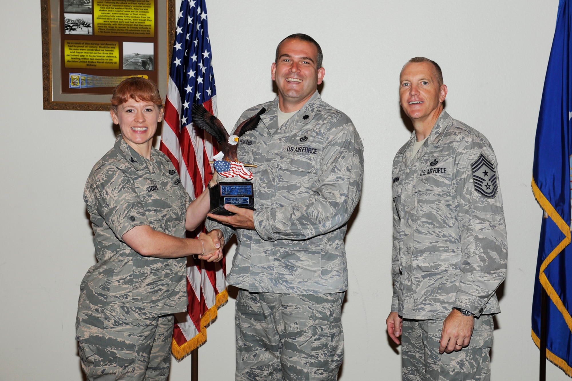 GOODFELLOW AIR FORCE BASE, Texas -- Col. Kimberlee Joos, 17th Training Wing Commander, and Chief Master Sgt. Scott Lumpkin, 17th TRW Command Chief, present the 17th Training Wing Unit of the Quarter to the 312th Training Squadron, during the wing quarterly awards ceremony, July 25. (U.S. Air Force photo by Staff Sgt. Austin Knox)