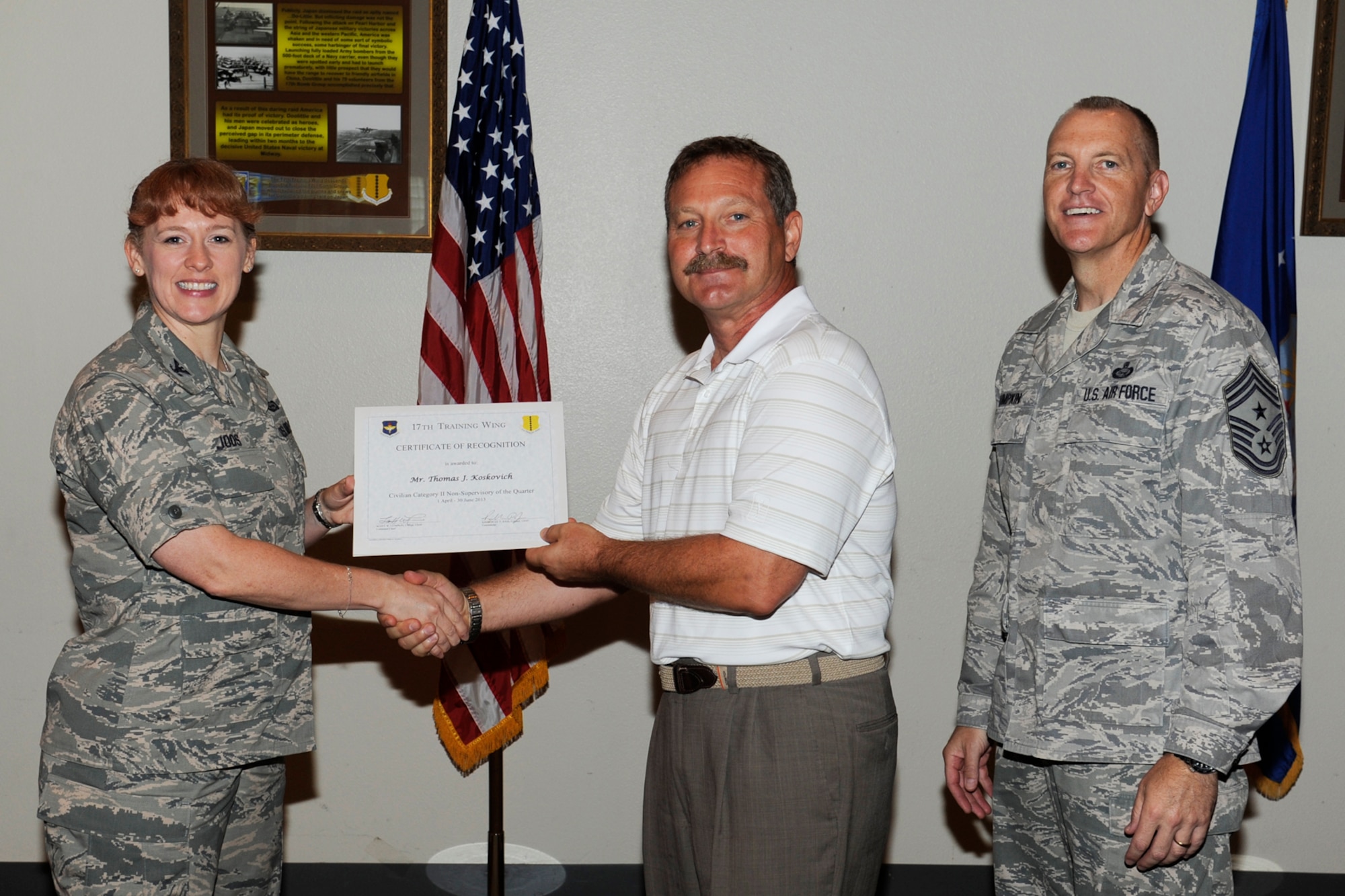 GOODFELLOW AIR FORCE BASE, Texas -- Col. Kimberlee Joos, 17th Training Wing Commander, and Chief Master Sgt. Scott Lumpkin, 17th TRW Command Chief, present the 17th Training Wing Civilian of the Quarter, Non-Supervisory, Category II to Thomas Koskovich, 17th Training Group, during the wing quarterly awards ceremony, July 25. (U.S. Air Force photo by Staff Sgt. Austin Knox)