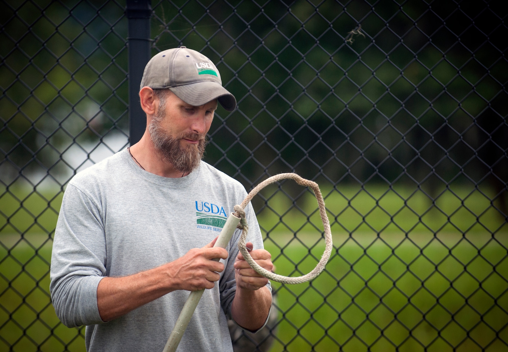 J.C. Griffin, U.S. Department of Agriculture wildlife biologist, prepares a snare for alligator trapping at Moody Air Force Base, Ga., July 25, 2013. The snare is used to help control the alligator and allow the alligator to expend its energy safely.  (U.S. Air Force photo by Senior Airman Jarrod Grammel/Released)
