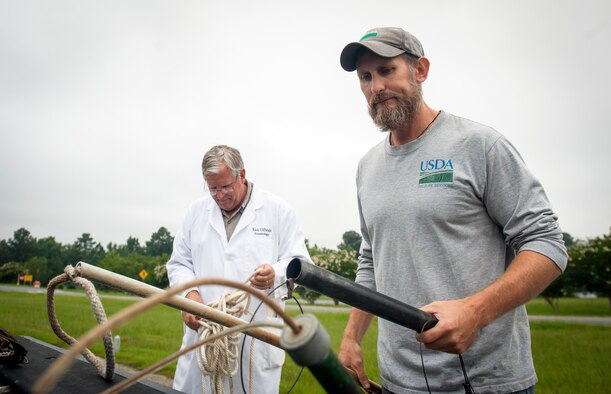 J.C. Griffin, U.S. Department of Agriculture wildlife biologist, and Rick Gilbride, 23d Civil Engineer Squadron entomologist, gather alligator-trapping tools at Moody Air Force Base, Ga., July 25, 2013. There are three qualified alligator trappers on Moody. (U.S. Air Force photo by Senior Airman Jarrod Grammel/Released)
