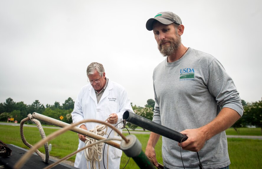 J.C. Griffin, U.S. Department of Agriculture wildlife biologist, and Rick Gilbride, 23d Civil Engineer Squadron entomologist, gather alligator-trapping tools at Moody Air Force Base, Ga., July 25, 2013. There are three qualified alligator trappers on Moody. (U.S. Air Force photo by Senior Airman Jarrod Grammel/Released)
