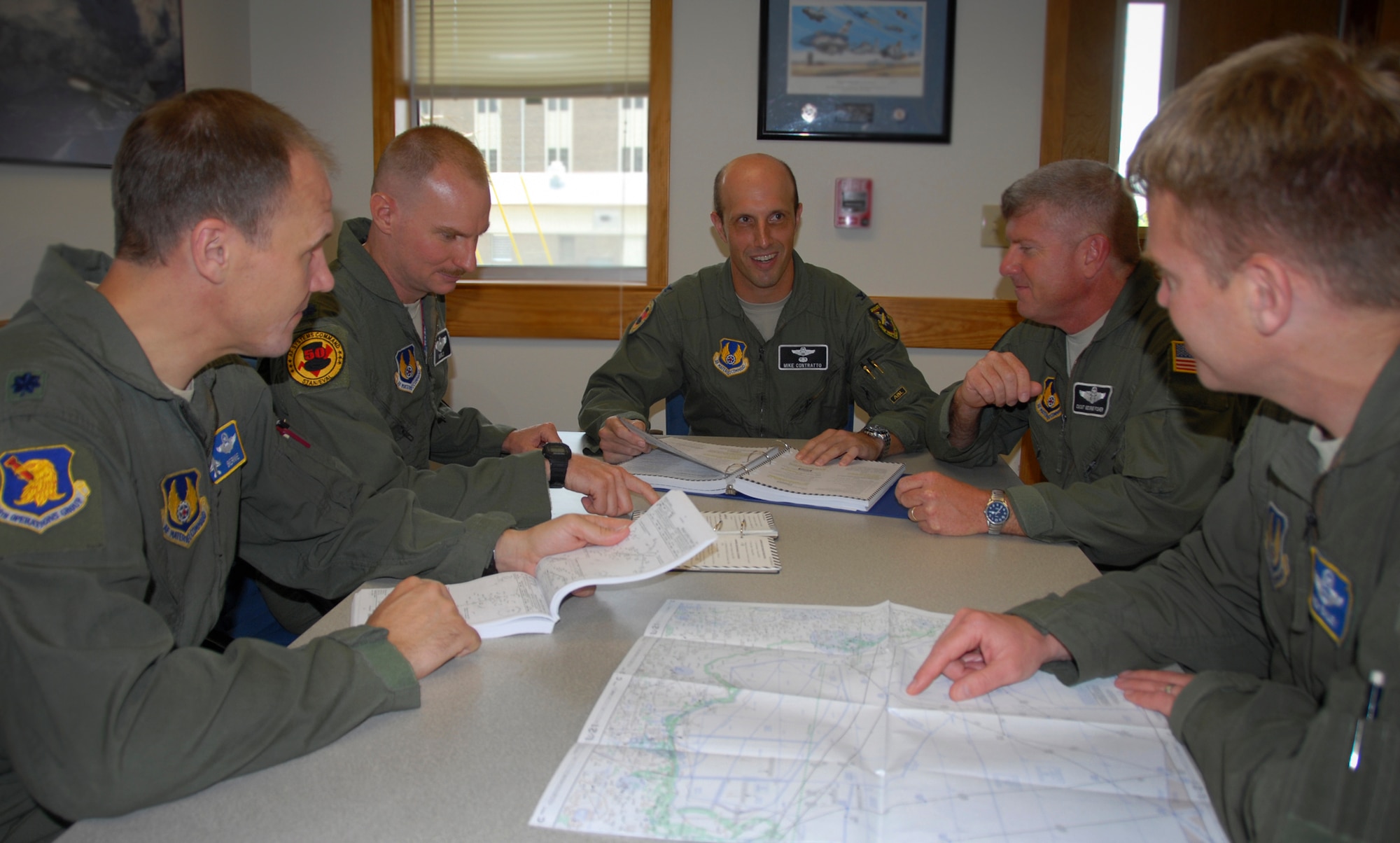 Col. Michael Contratto, the Air Force Material Command/A3V Flight Operations and Standardization/Evaluation division chief, holds a flight briefing with staff members.  The division celebrated 50 years of service July 26.  (U.S. Air Force photo/Kevin Gaddie)