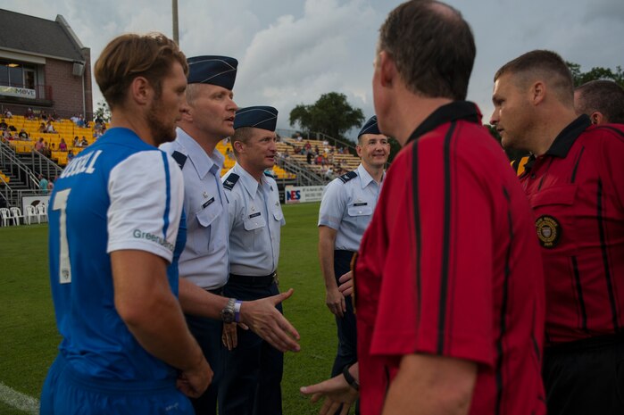 Col. Darren Hartford (second from left), 437th Airlift Wing commander, Col. James Fontanella (third from left), 315th Airlift Wing commander, and Col. Michael Mongold (center), 628th Mission Support Group commander, prepare for the ceremonial coin toss July 27, 2013, during Military Appreciation Night at Blackbaud Stadium, Daniel Island, S.C. The Charleston Battery hosted Military Appreciation Night to show their support for the local military community. (U.S. Air Force photo/Senior Airman Ashlee Galloway)