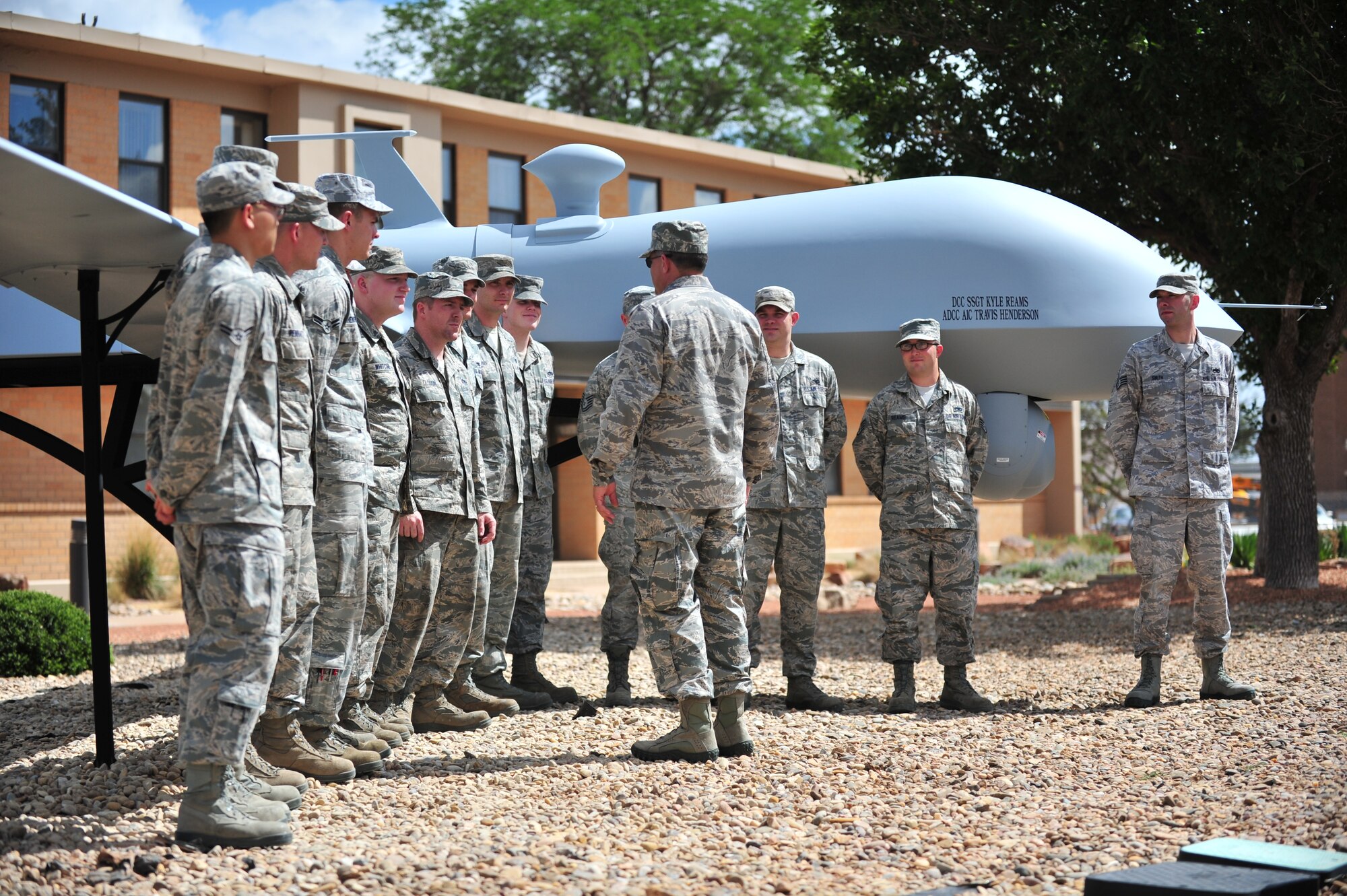 U.S. Air Force Air Commandos with the 27th Special Operations Maintenance Squadron meet with Brig. Gen. Buck Elton, former 27th Special Operations Wing commander, July 19, 2013, at Cannon Air Force Base, N.M.  The squadron was congratulated by wing leadership after they completed the project of building a static display MQ-1 Predator for Building 1.  (U.S. Air Force photo/Tech. Sgt. Josef Cole)