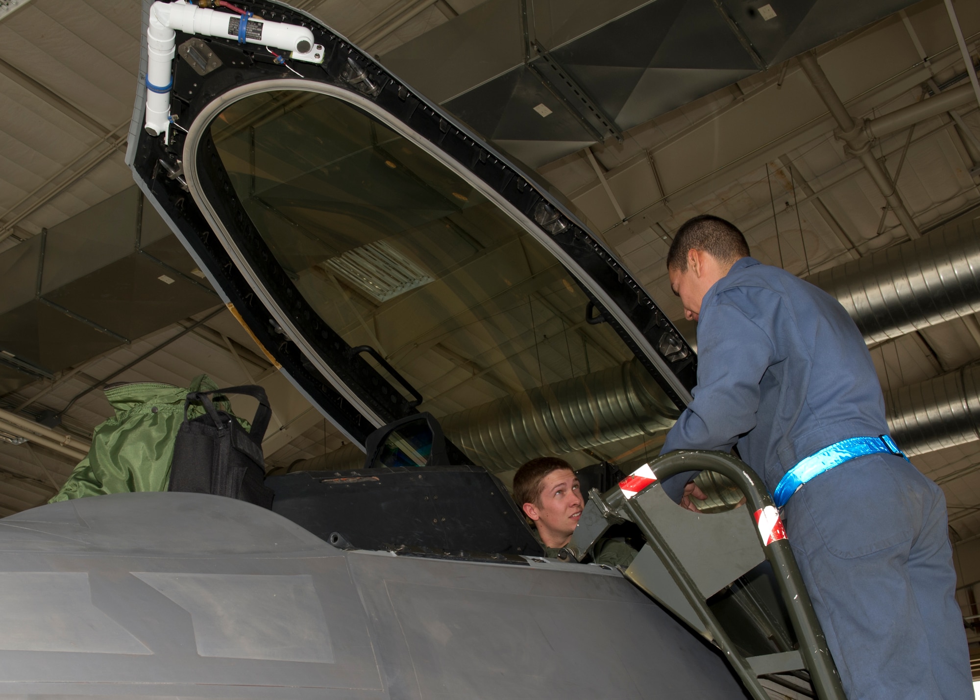 1st Lt. Stephen Renner, 7th Fighter Squadron F-22 Raptor pilot, speaks to Senior Airman Ricardo Rodriguez, 44th Aircraft Maintenance Squadron F-22 crew chief, before flight at Holloman Air Force Base, N.M., July 25. The F-22 features advances in low-observable technologies provide significantly improved survivability and lethality against air-to-air and surface-to-air threats. (U.S. Air Force photo by Senior Airman Kasey Close/Released)