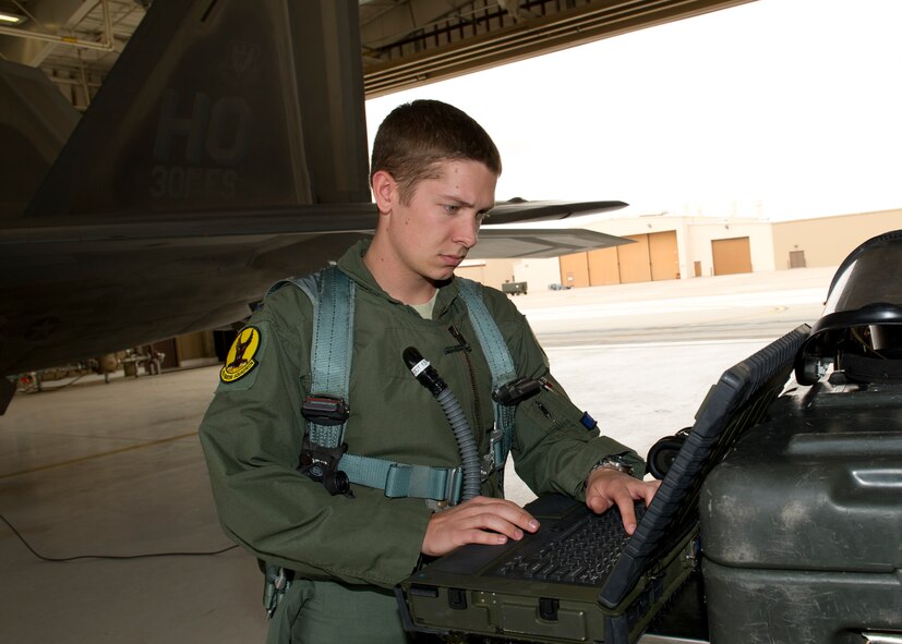1st Lt. Stephen Renner, 7th Fighter Squadron F-22 Raptor pilot, examines the maintenance order on the aircraft before flight at Holloman Air Force Base, N.M., July 25. The F-22’s sophisticated aerodesign, advanced flight controls, thrust vectoring, and high thrust-to-weight ratio provide it the capability to outmaneuver other fighter aircraft. (U.S. Air Force photo by Senior Airman Kasey Close/Released)