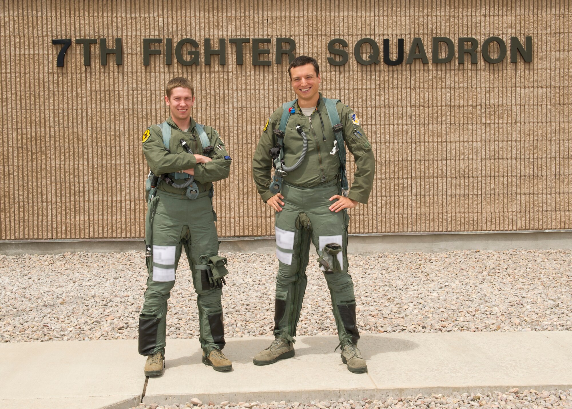 1st Lts. Stephen Renner and Andrew Van Timmeren, 7th Fighter Squadron F-22 Raptor pilots, stand outside of their squadron before stepping out to their aircrafts at Holloman Air Force Base, N.M., July 25. The F-22 has a combination of stealth, supercruise, maneuverability, and integrated avionics, and when coupled with improved supportability, represents an exponential leap in warfighting capabilities. (U.S. Air Force photo by Senior Airman Kasey Close/Released)