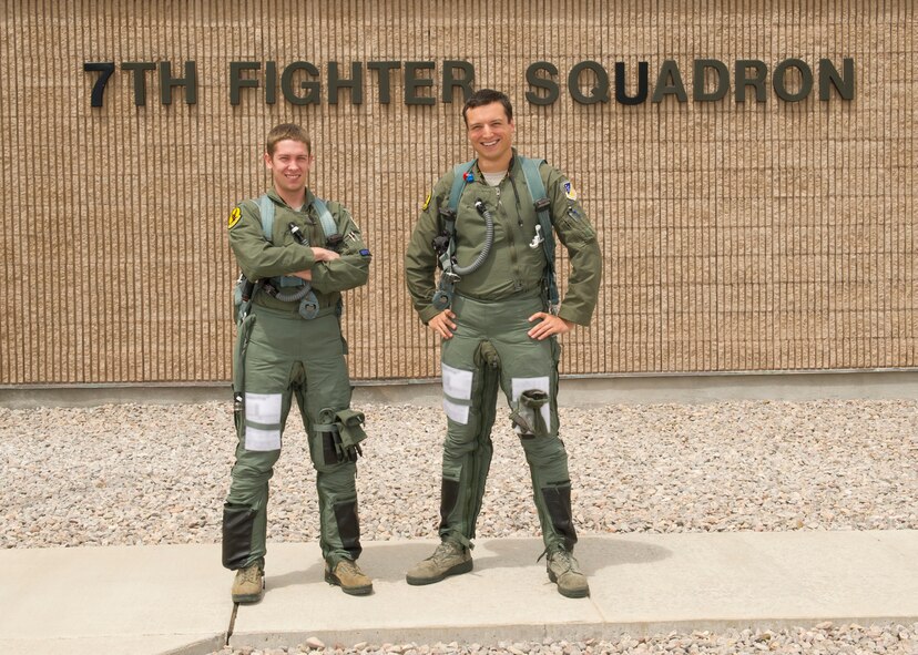 1st Lts. Stephen Renner and Andrew Van Timmeren, 7th Fighter Squadron F-22 Raptor pilots, stand outside of their squadron before stepping out to their aircrafts at Holloman Air Force Base, N.M., July 25. The F-22 has a combination of stealth, supercruise, maneuverability, and integrated avionics, and when coupled with improved supportability, represents an exponential leap in warfighting capabilities. (U.S. Air Force photo by Senior Airman Kasey Close/Released)