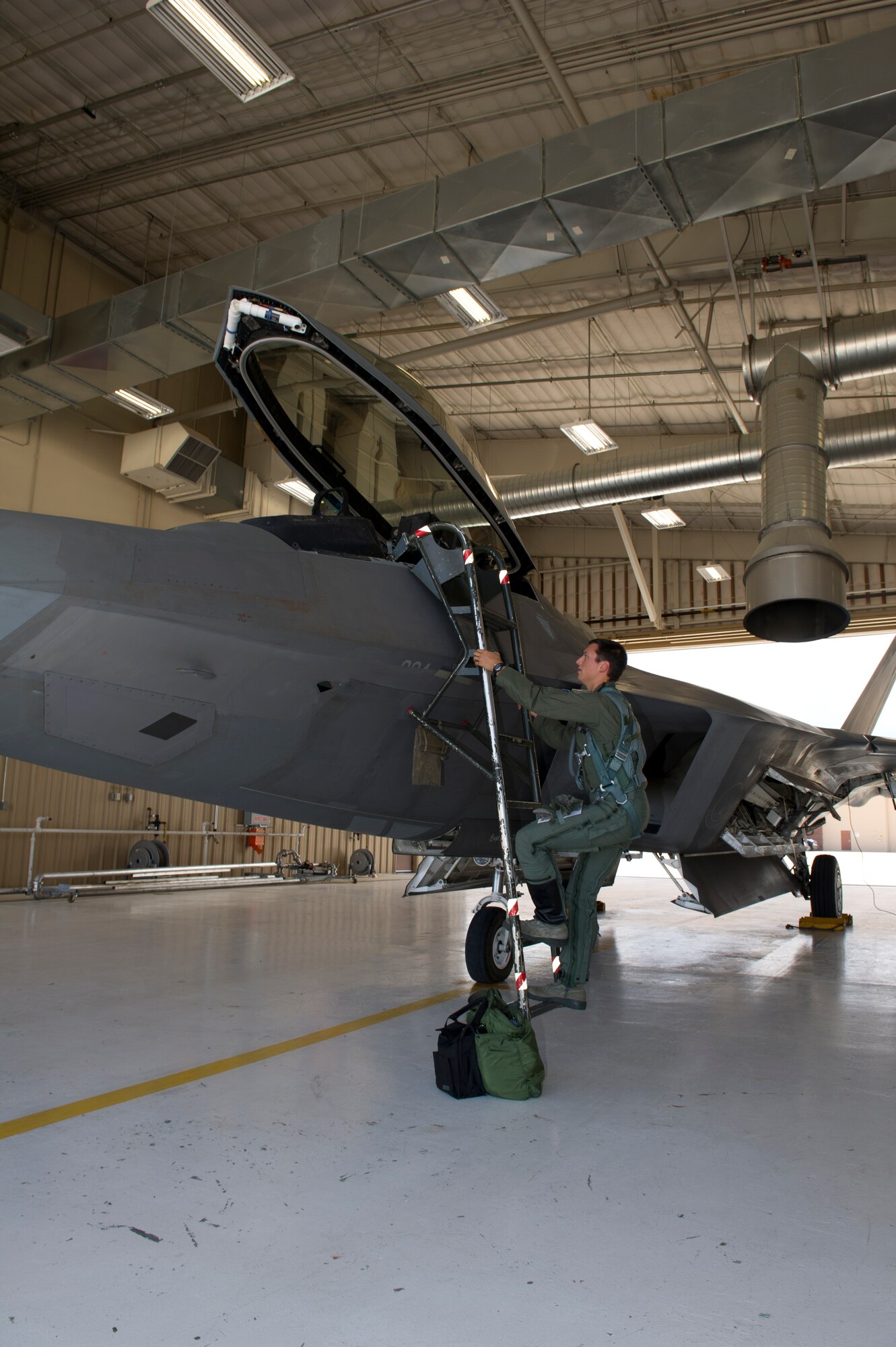 1st Lt. Andrew Van Timmeren, 7th Fighter Squadron F-22 Raptor pilot, climbs into an F-22 at Holloman Air Force Base, N.M., July 24. The F-22’s sophisticated aerodesign, advanced flight controls, thrust vectoring, and high thrust-to-weight ratio provide it the capability to outmaneuver other fighter aircraft. (U.S. Air Force photo by Senior Airman Kasey Close/Released)