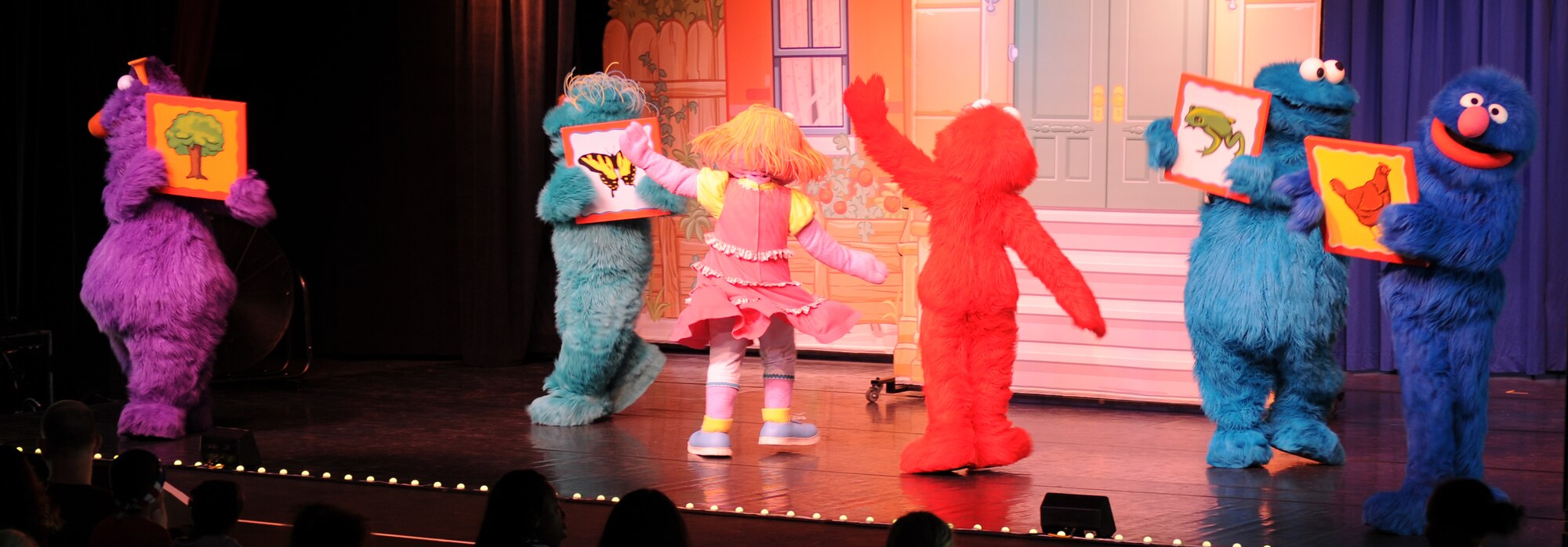 Sesame Street characters perform for members of the KMC during the “Sesame Street USO Experience for Military Families” show, July 24, 2013, Kleber Kaserne, Germany. Members of the show are traveling to U.S. military bases around the world in support of military members and their families. (U.S. Air Force photo/Airman 1st Class Holly Mansfield)