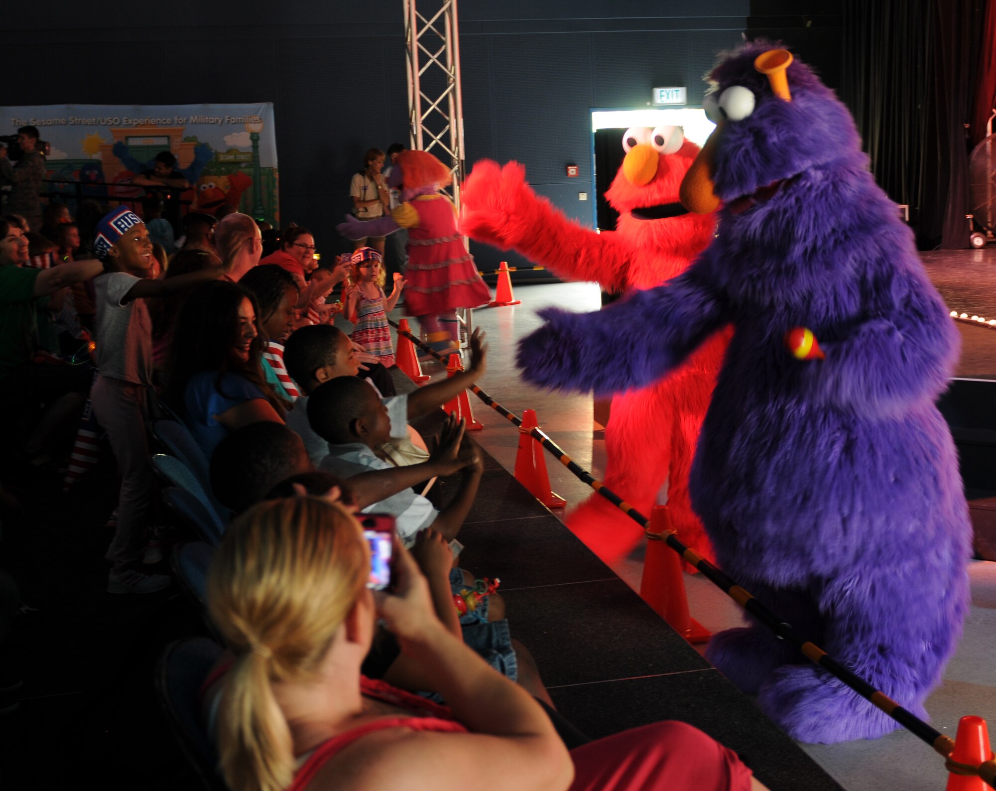 Sesame Street characters perform for members of the KMC during the “Sesame Street USO Experience for Military Families” show, July 24, 2013, Kleber Kaserne, Germany. Members of the show are traveling to U.S. military bases around the world in support of military members and their families. (U.S. Air Force photo/Airman 1st Class Holly Mansfield)