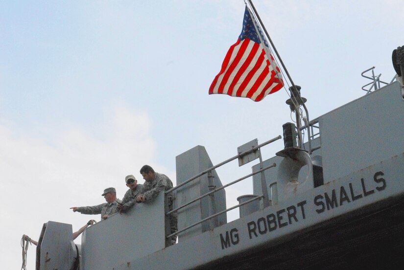 Soldiers of the 805th Transportation Detachment look down from aboard the Maj. Gen. Robert Smalls, a Logistics Support Vessel, as it prepares to dock at Fort Eustis, Va., July 24, 2013. Thirty-one Soldiers returned aboard the Smalls, ending their 10-month deployment to the Persian Gulf in support of Operating Enduring Freedom. (U.S. Army photo by Sgt. Marc Loi/Released)