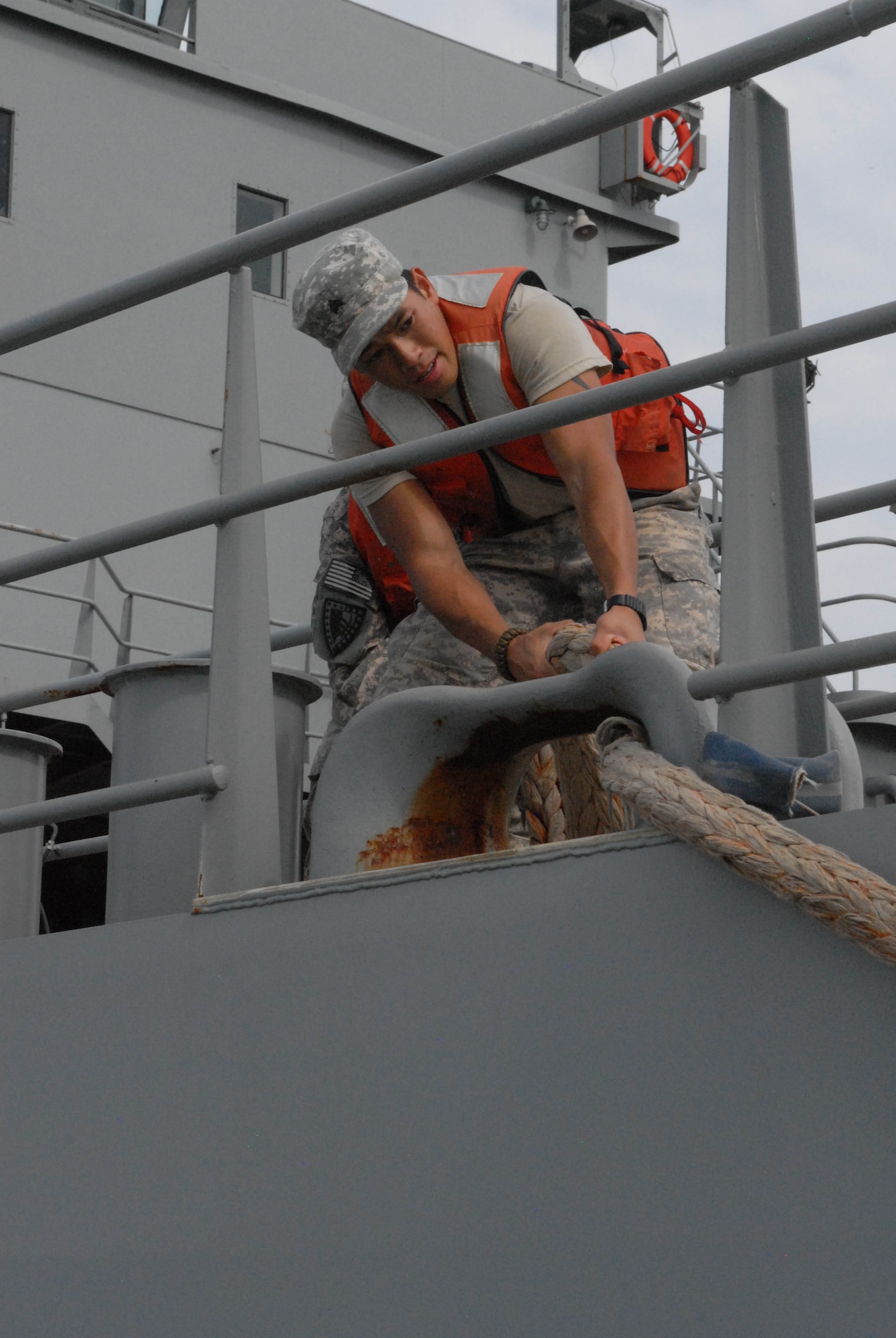 A Soldier from the 805th Transportation Detachment prepares to dock the Maj. Gen. Robert Smalls, a Logistics Support Vessel, at Fort Eustis, Va., July 24, 2013.  Thirty-one Soldiers returned aboard the Smalls, ending their 10-month deployment to the Persian Gulf in support of Operating Enduring Freedom. (U.S. Army photo by Sgt. Marc Loi/Released)