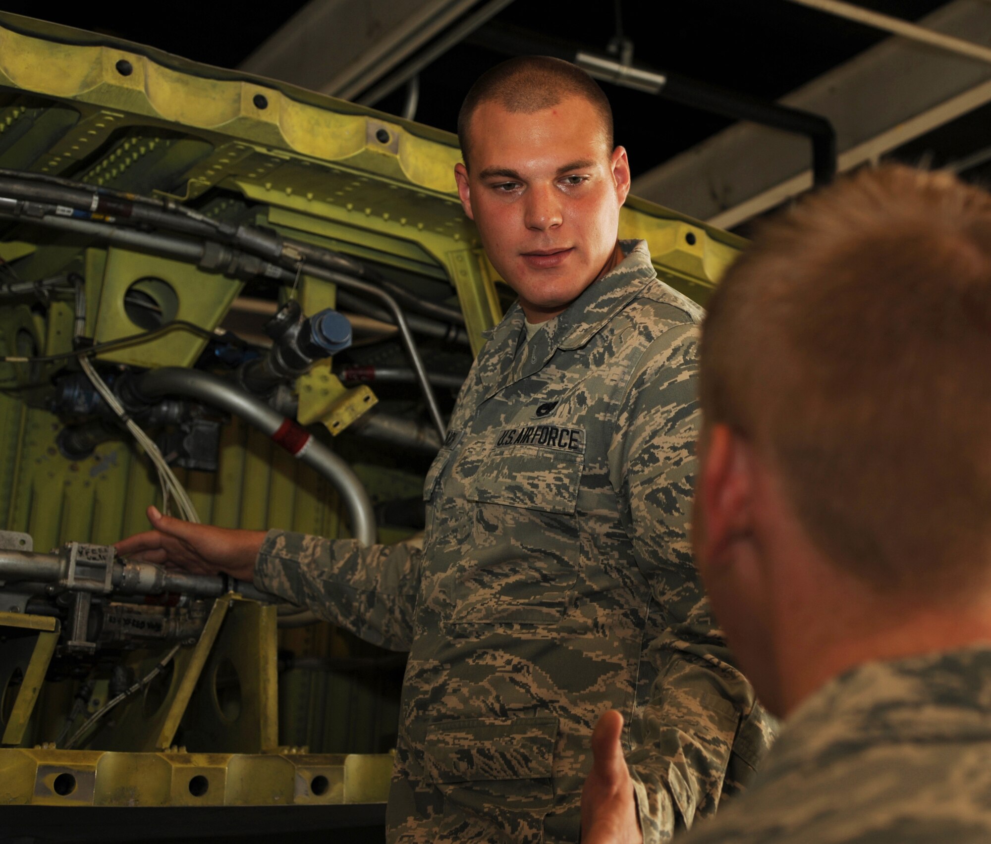 Airman 1st Class Joshua Dedenbach, a 19th Component Maintenance Squadron aircraft fuel systems apprentice, trains a 19th CMS field systems apprentice on the correct way to install and remove parts on a No. 3 dry bay from the wing of an aircraft July 22, 2013, at Little Rock Air Force Base, Ark. Dedenbach was a vital team member in the repair of an elusive C-130 single point refuel drain pump malfunction. The repairs he completed returned a 48 million dollar aircraft to full mission capability two hours ahead of schedule. (U.S. Air Force photo by Airman 1st Class Harry Brexel)