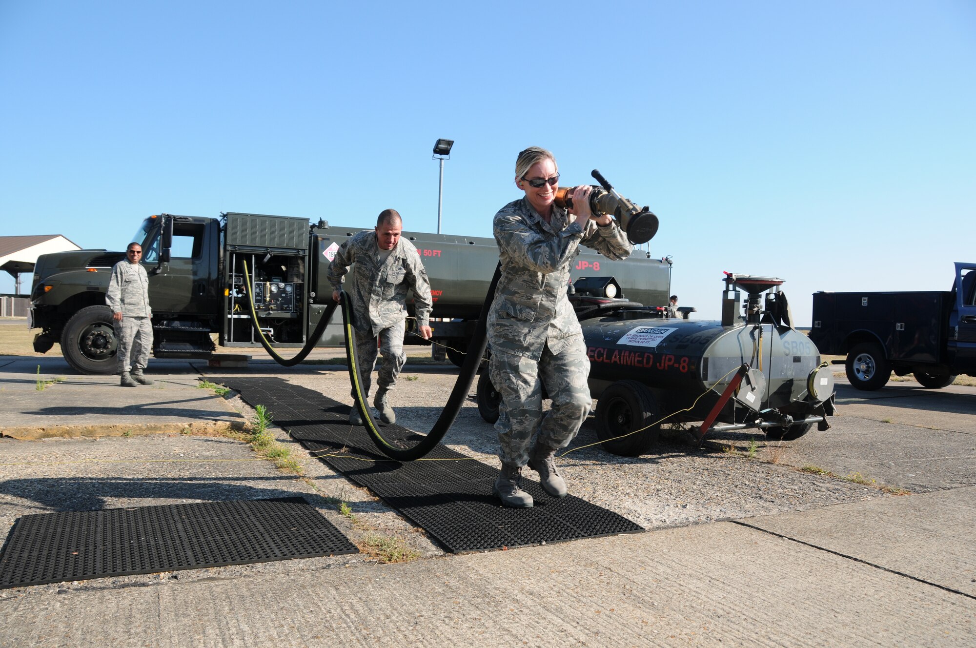 Col. Anne Gunter, 944th Mission Support Group commander, and Tech. Sgt. Mike Kuehler, 944th Logistics Readiness Squadron fuels craftsman, both from Luke AFB, Ariz., pull the hose from an R-11 refueling truck during a checkpoint inspection of the vehicle prior to the truck being used for the day, while on annual tour July 18, 2013 on RAF Mildenhall, England.  The 944th LRS worked and trained with the the 100th LRS, an active duty unit stationed at RAF Mildenhall, throughout the 944th’s tour. (U.S. Air Force photo by Staff Sgt. Joshua Nason/Released)