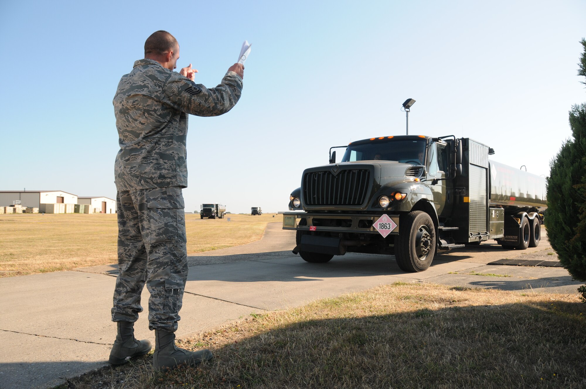 Tech. Sgt. Mike Kuehler, 944th Logistics Readiness Squadron, Luke AFB, Ariz., ground guides the driver of an R-11 refueling truck during a checkpoint inspection of the vehicle prior to the truck being used for the day, while on annual tour July 18, 2013,at RAF Mildenhall, England. The 944th LRS worked and trained with the 100th LRS, an active duty unit stationed at RAF Mildenhall, throughout the 944th’s tour. (U.S. Air Force photo by Staff Sgt. Joshua Nason/Released)