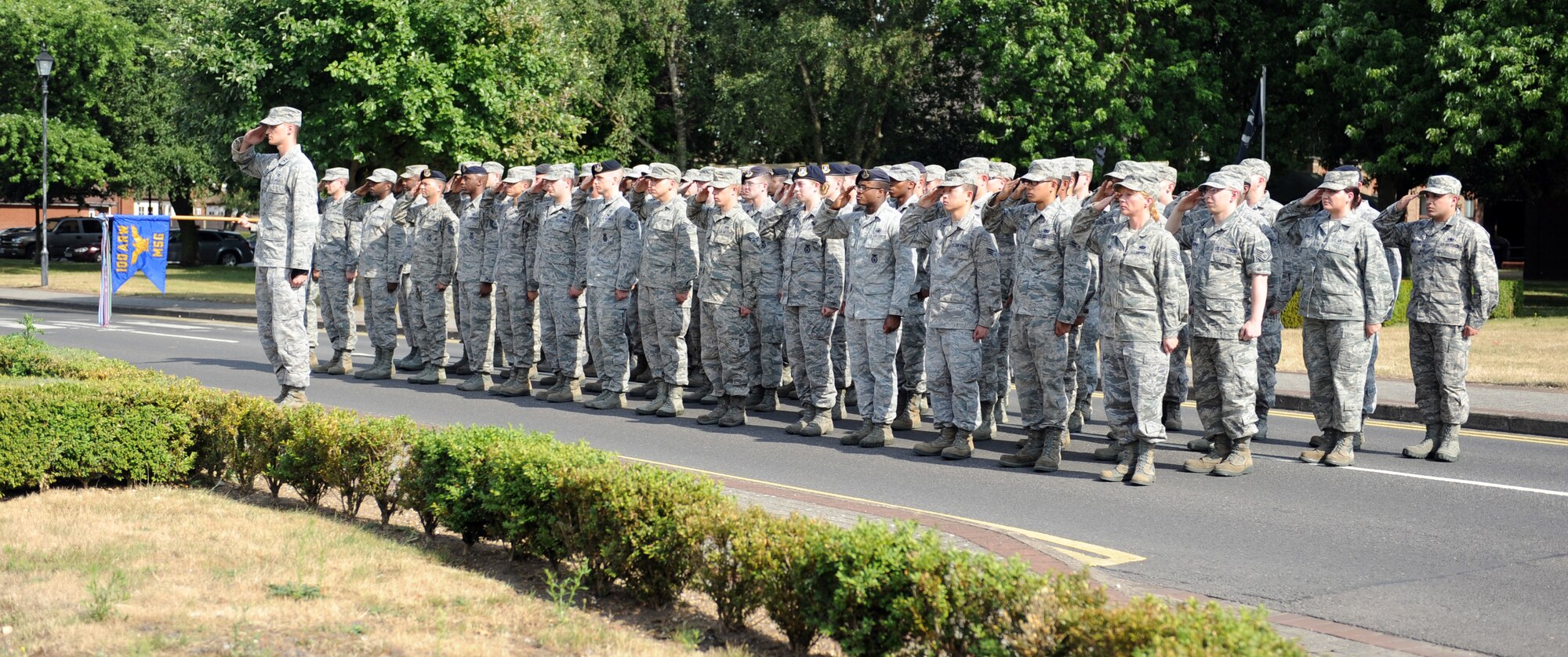 Members of the 100th Mission Support Group salute the U.S. flag as it’s lowered during the monthly retreat ceremony July 26, 2013, on RAF Mildenhall, England. Retreat is a long-standing tradition honoring the flag and signaling the end of the duty day. (U.S. Air Force photo by Airman 1st Class Preston Webb/Released)